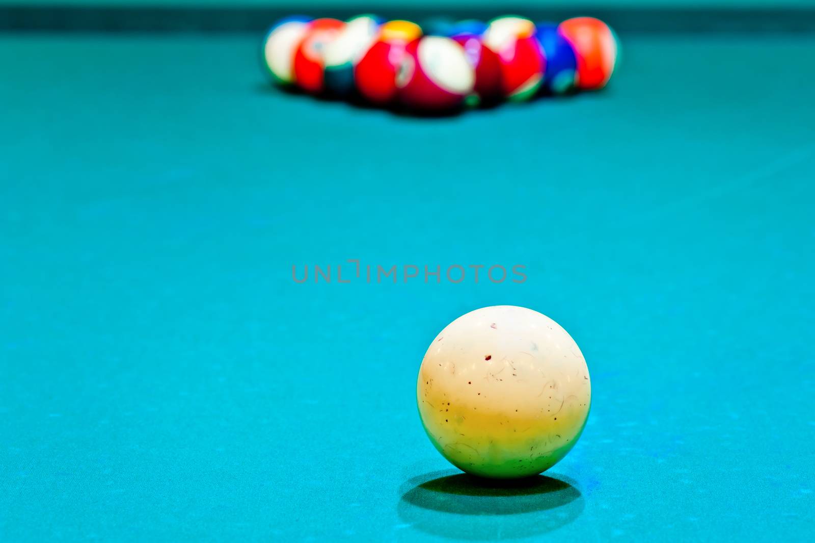 white cue ball close-up on a pool table covered with green baize by kosmsos111