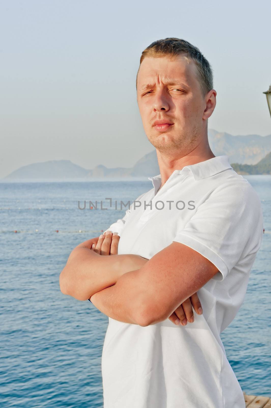 a man with a serious expression on his face is in a closed position against the sea by kosmsos111