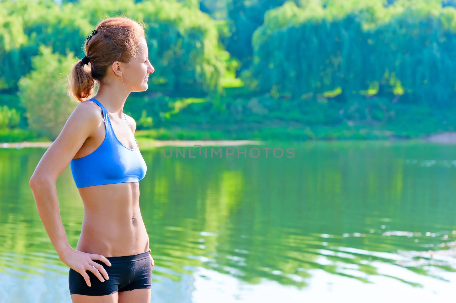 shapely, toned woman in sportswear rest on the nature by kosmsos111