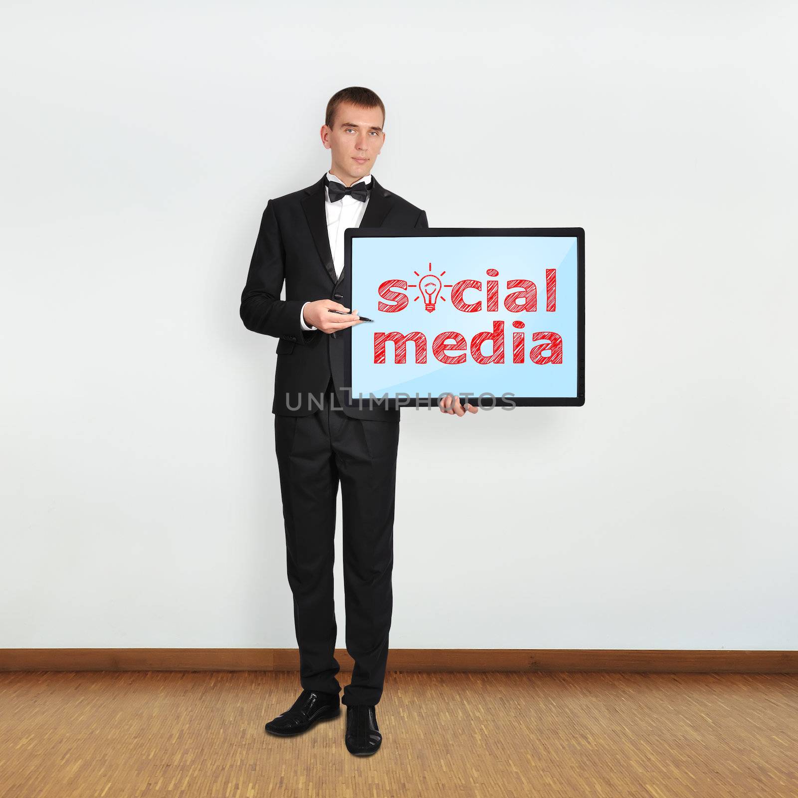 businessman in room holding plasma panel with seo