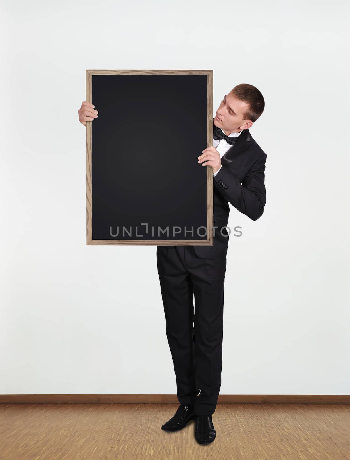 businessman holding blackboard by vetkit