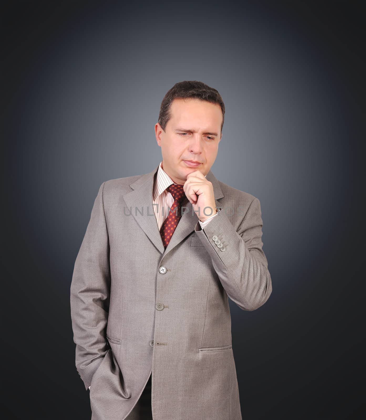 thinking businessman in suit on black background