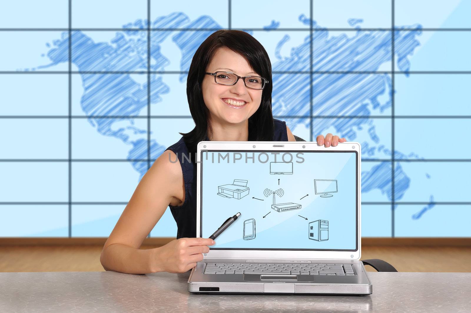 woman sitting in office and pointing to computer network