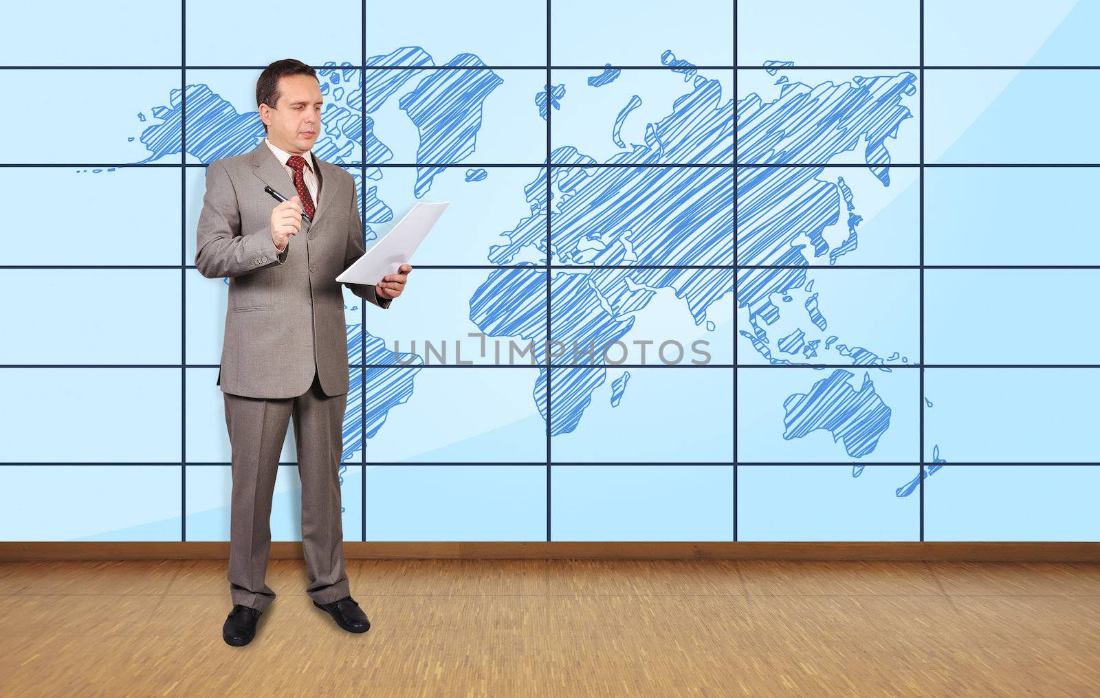 businessman in office and world map on plasma wall
