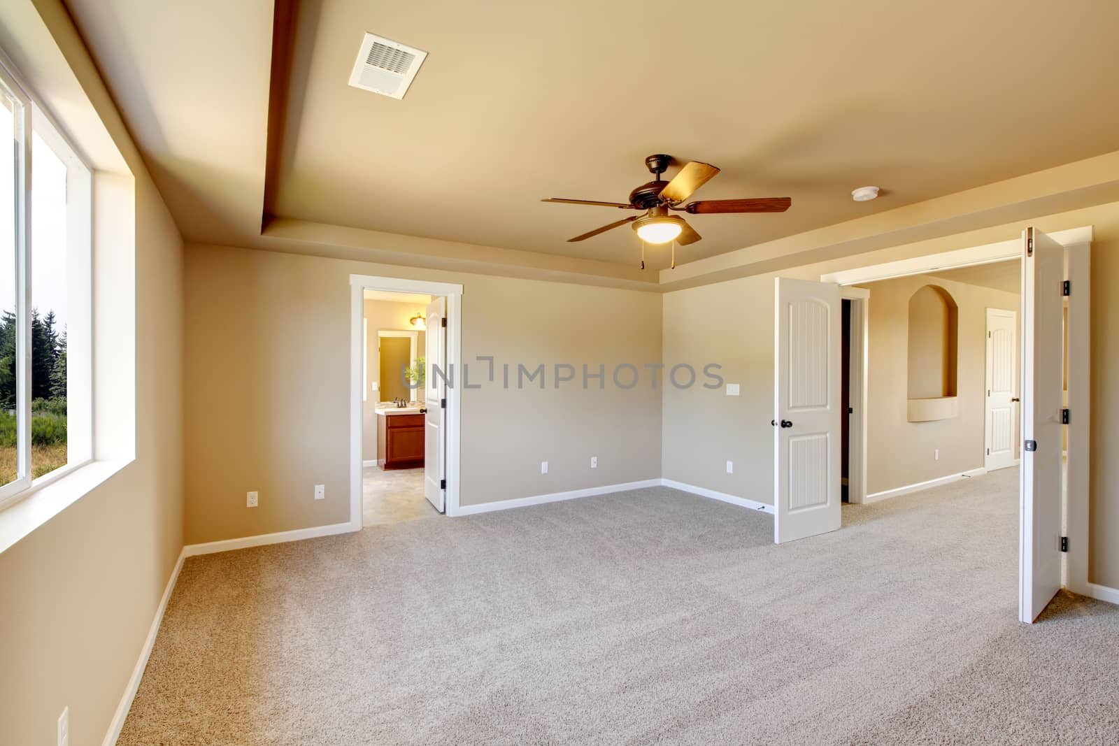 New empty room with beige carpet.. New house development in USA.