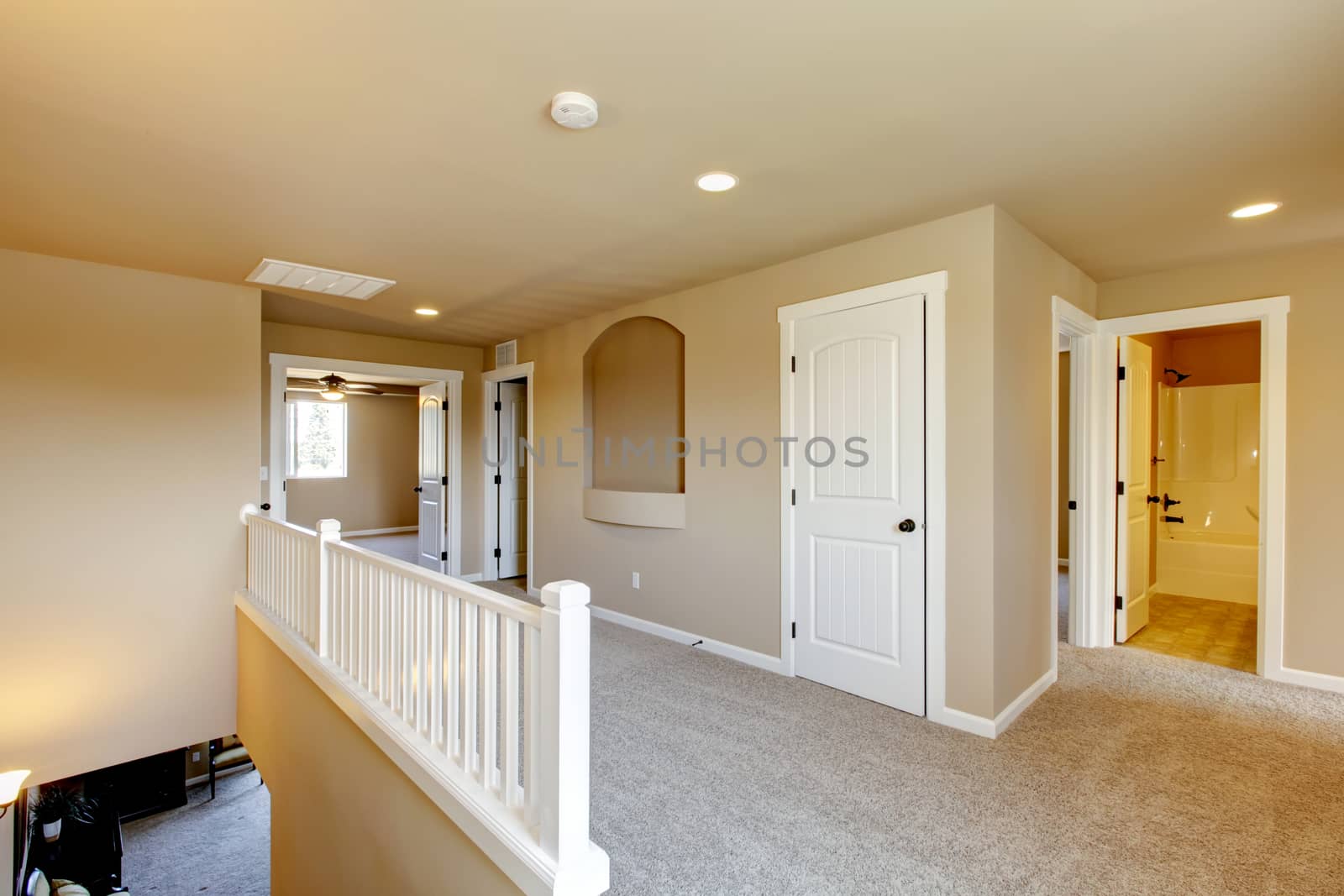 New empty room with beige carpet.. New house development in USA.