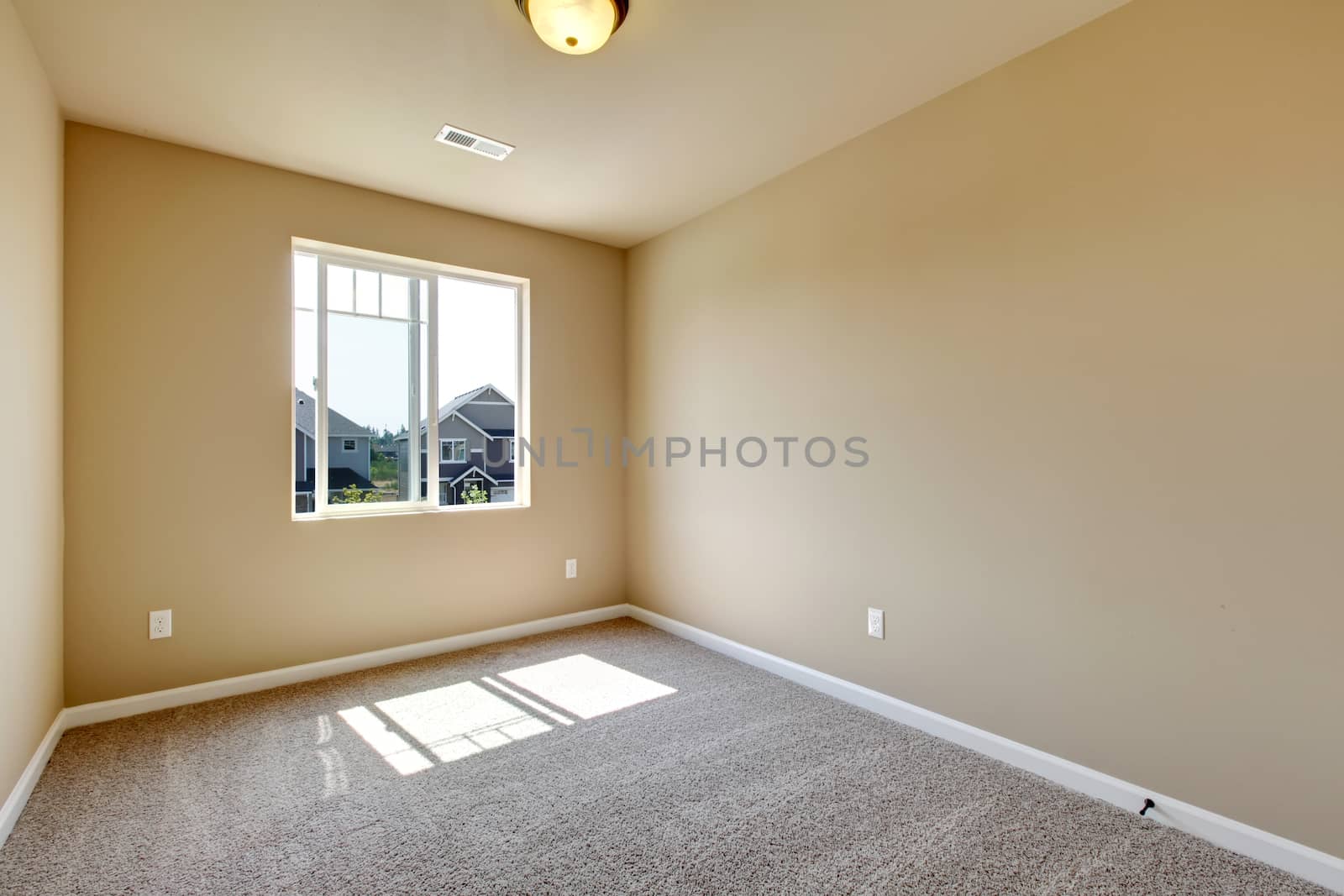 New empty room with beige carpet.. New house development in USA.