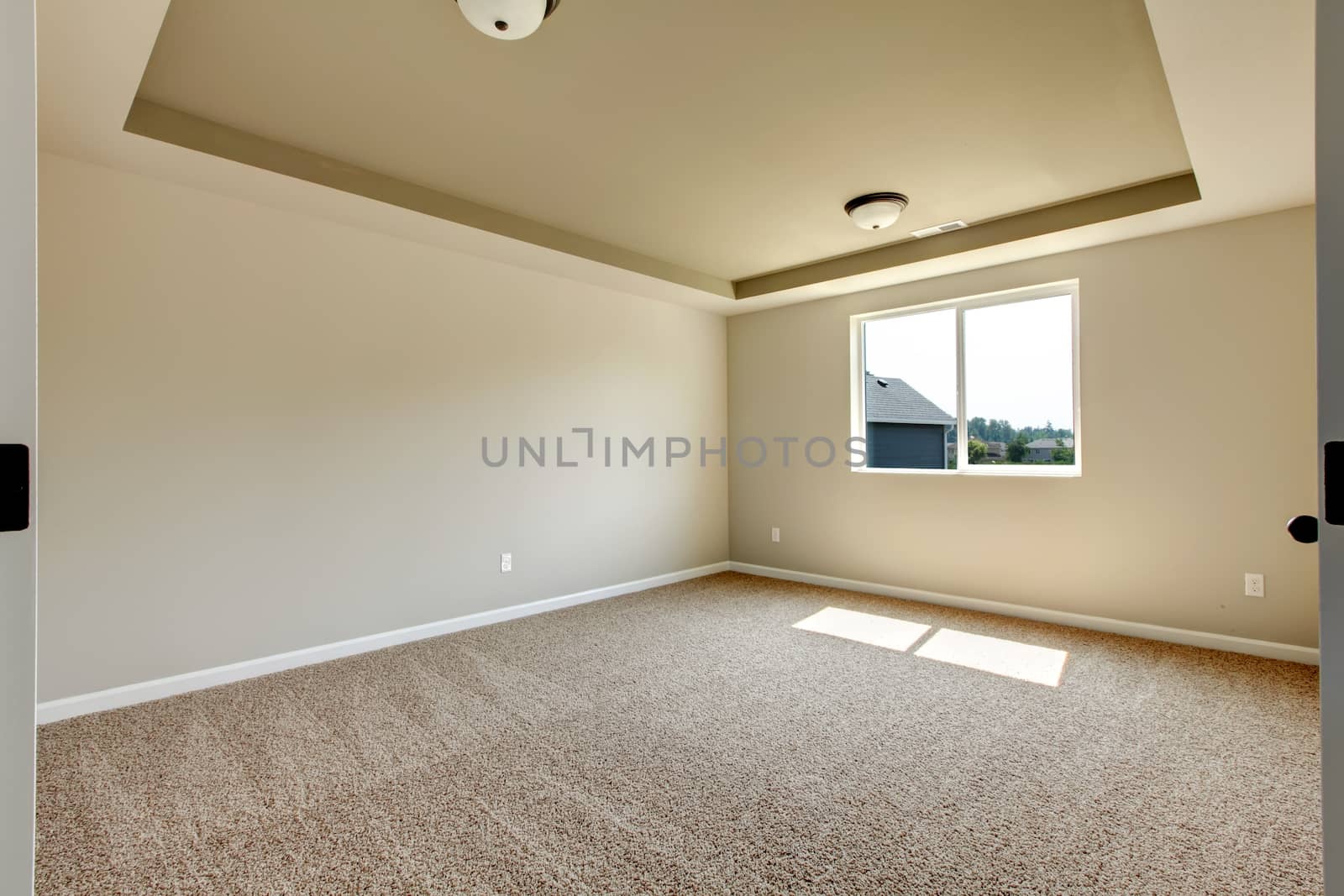 New empty room with beige carpet.. New house development in USA.