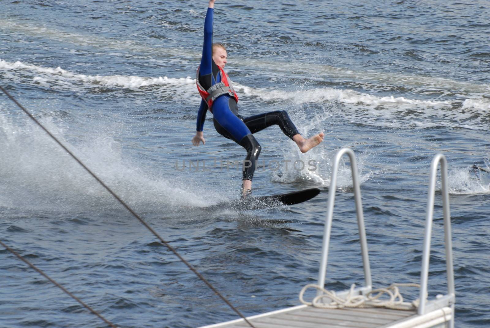 Boy falling on water skis