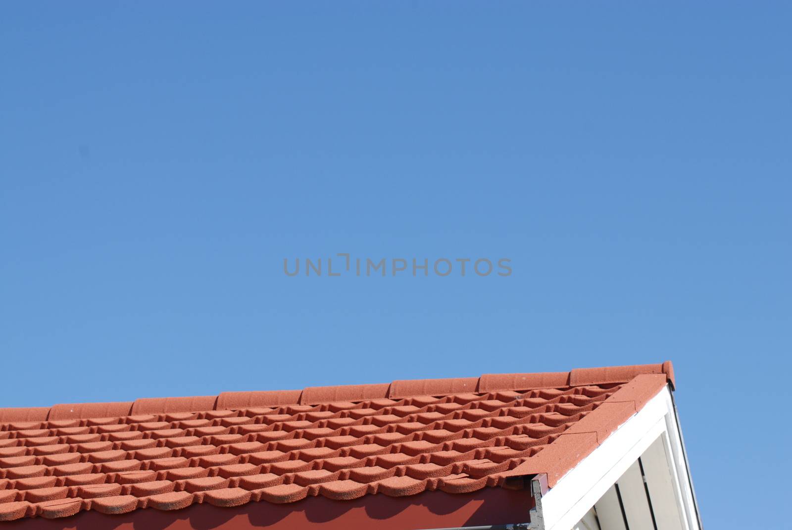 Roof with red tiles and blue sky