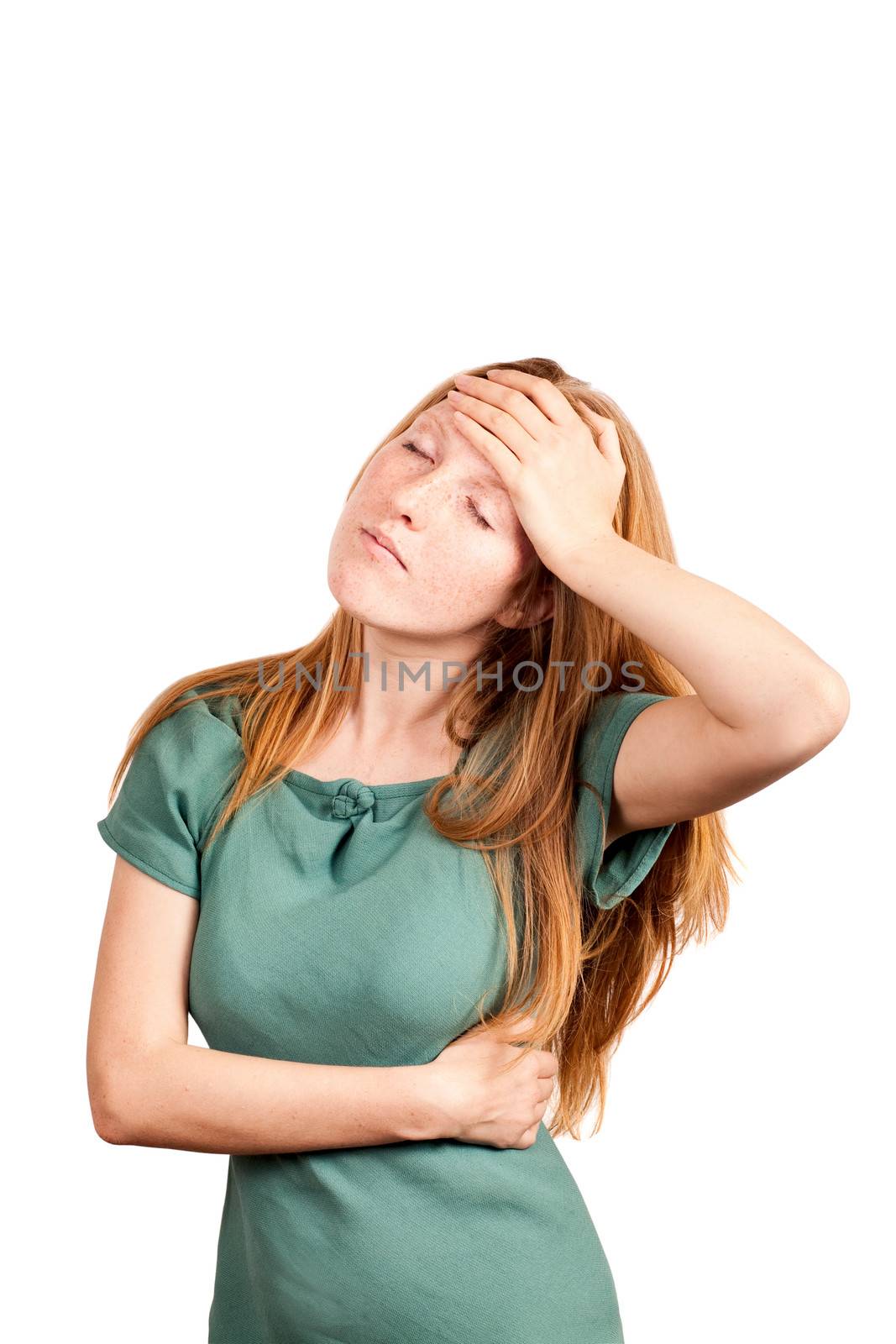 Red-haired woman expressing fatigue and headache