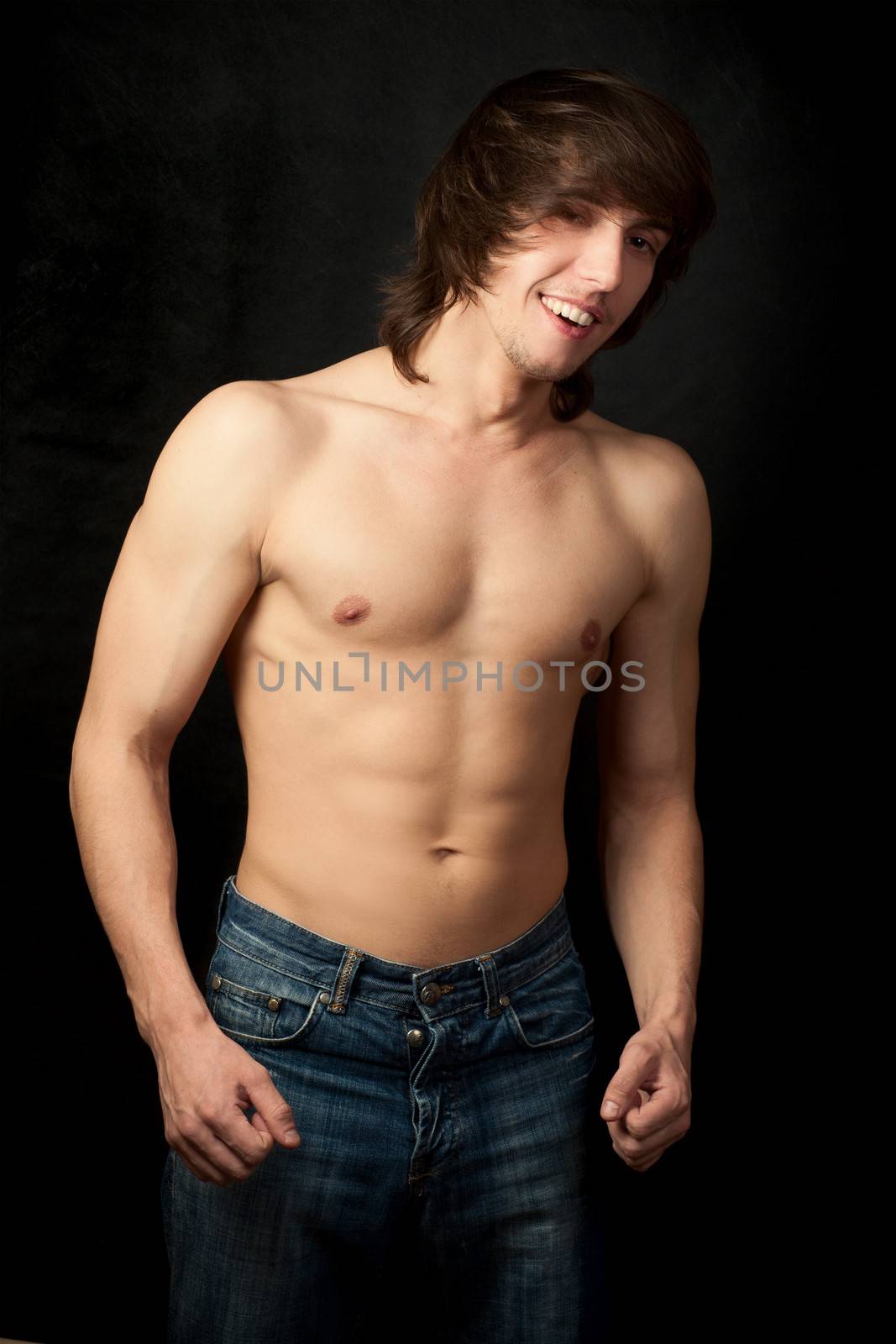 Sexy muscular man isolated on black background