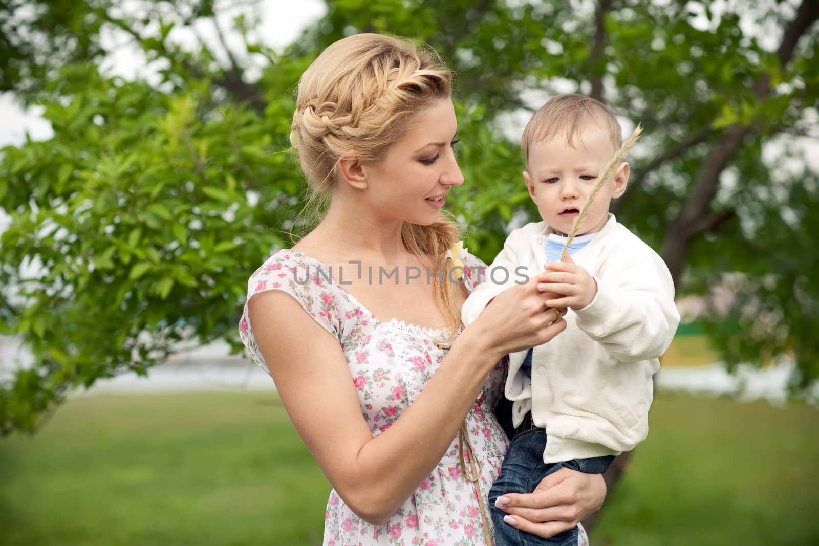 mother is teaching her baby son to get to know the world