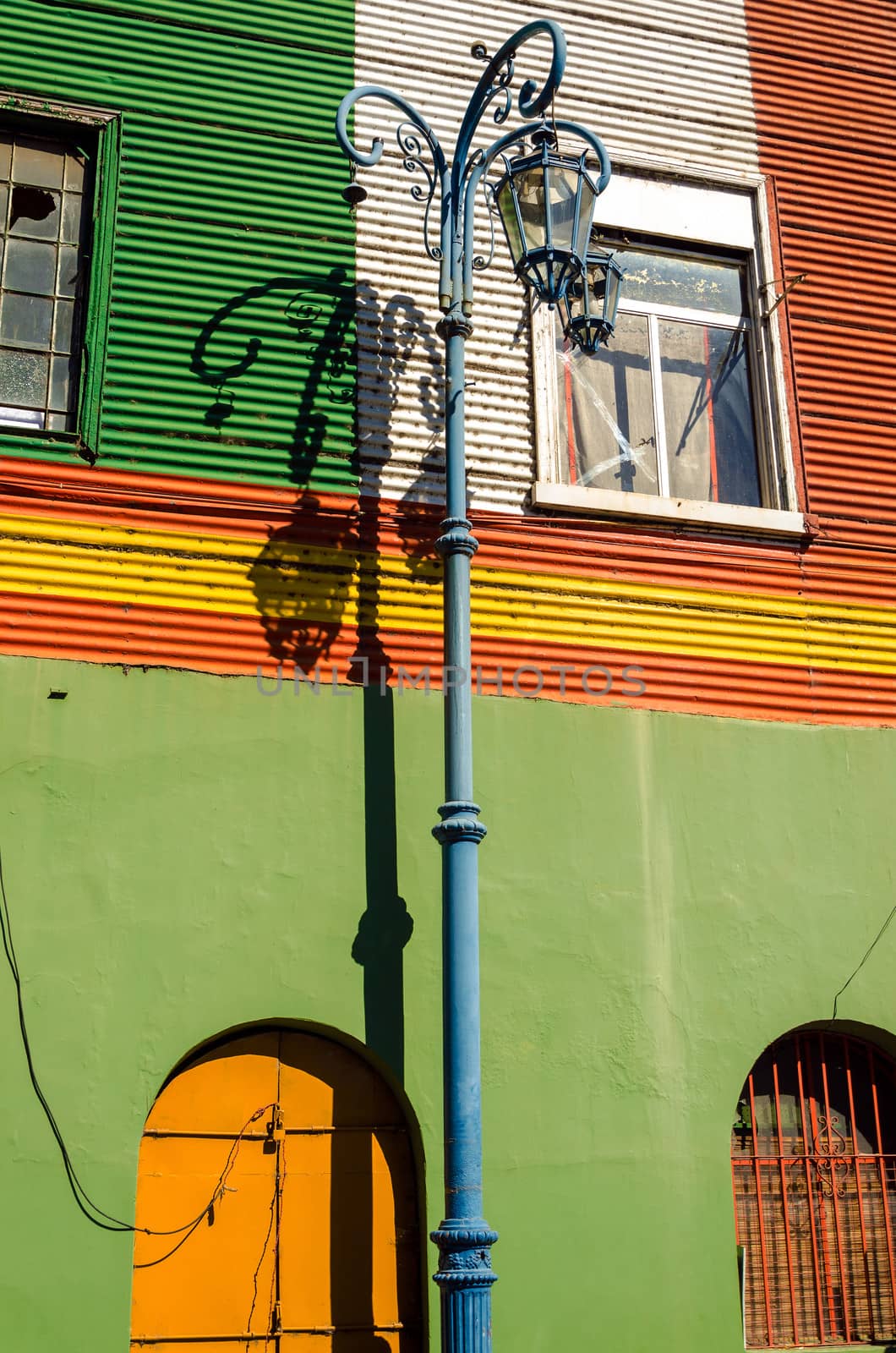 Streetlight set against a colorful wall in La Boca neighborhood of Buenos Aires, Argentina