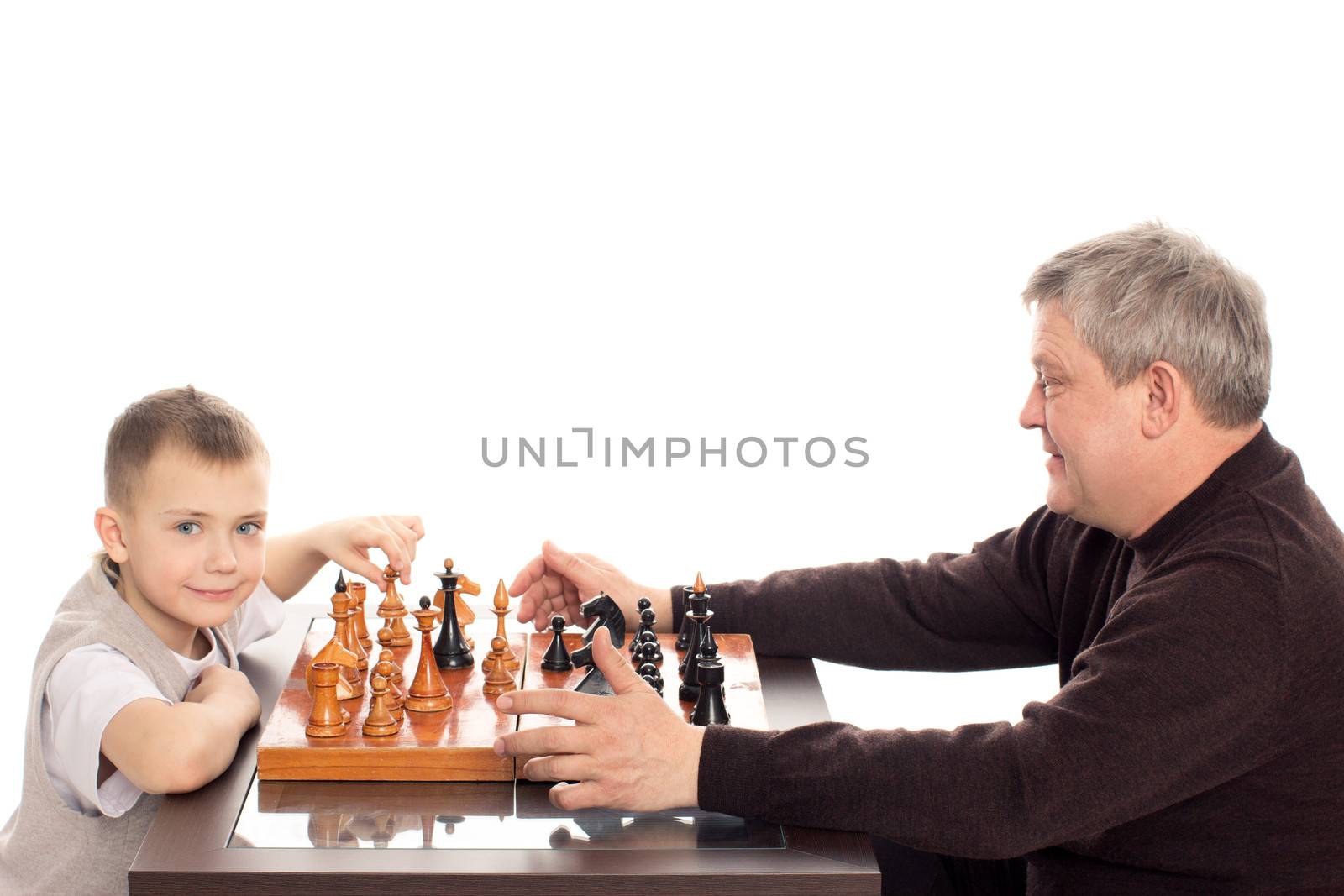 Grandfather and Grandson having a game of chess on a white background