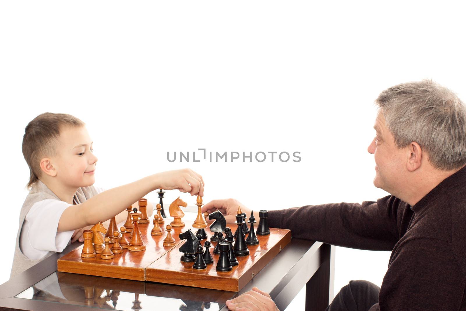 Grandfather and Grandson having a game of chess on a white background