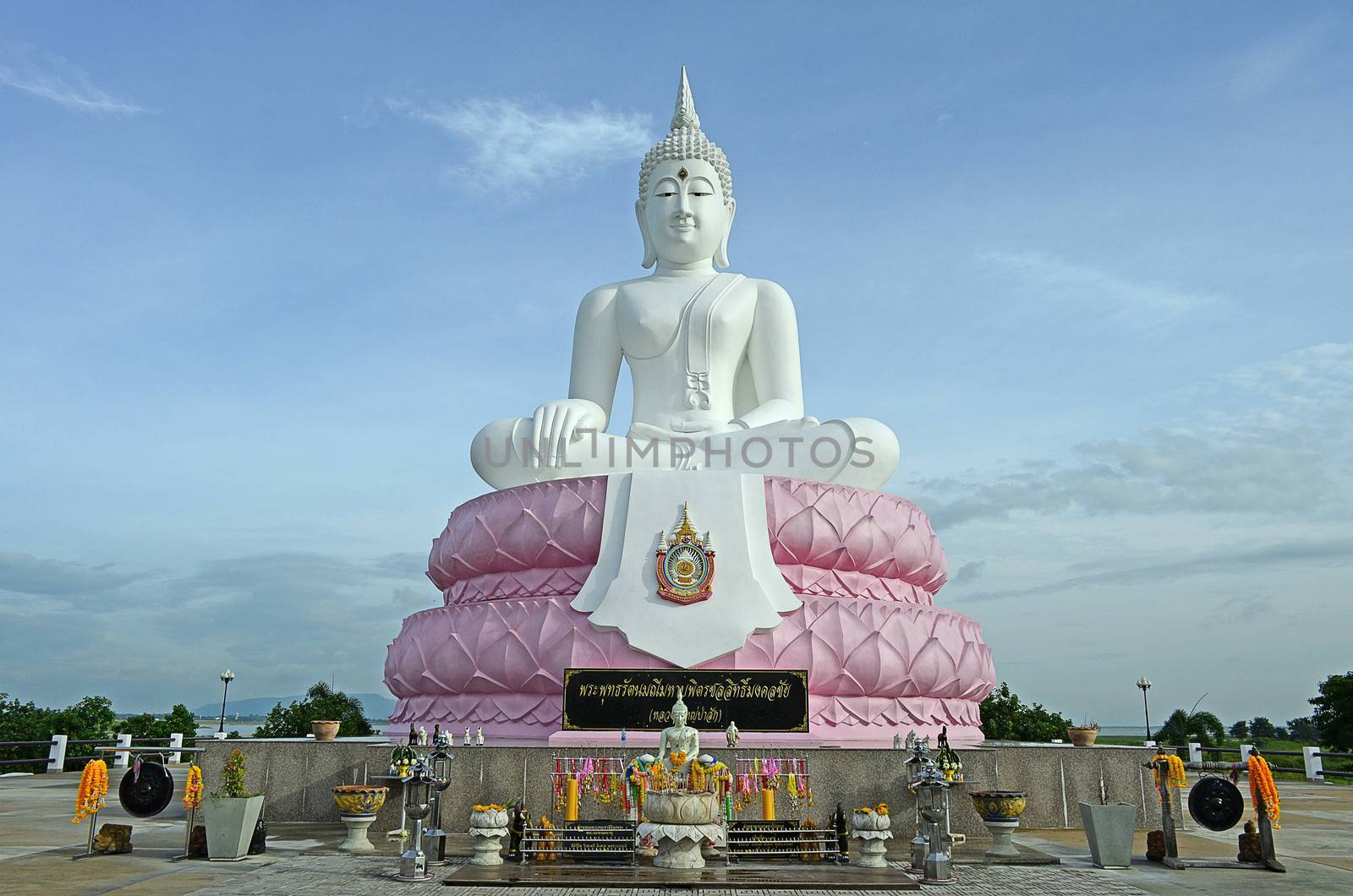 The White Seated Buddha Image of Subduing Mara Attitude with Blue Sky
