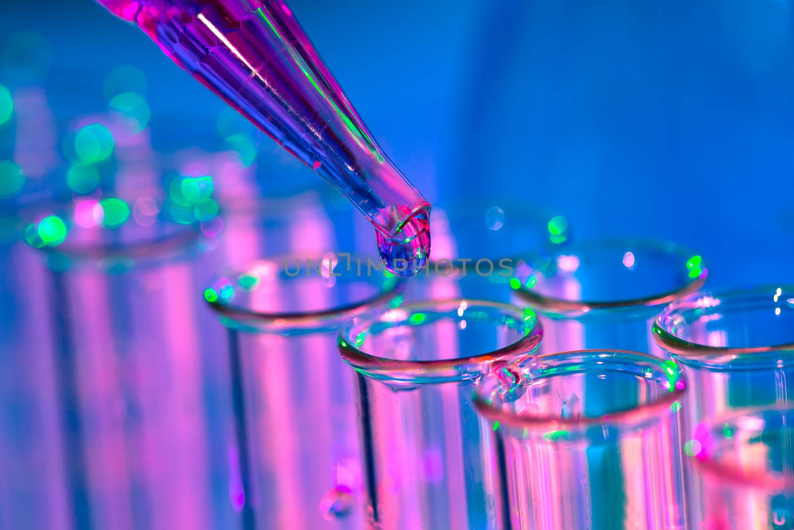 Pipette adding fluid to one of several test tubes