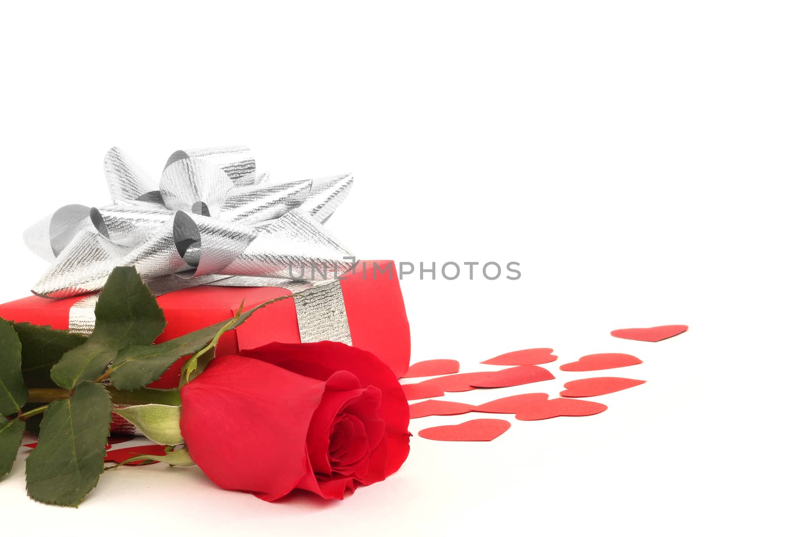 Valentines Day gift in red box with rose and small hearts isolated on white