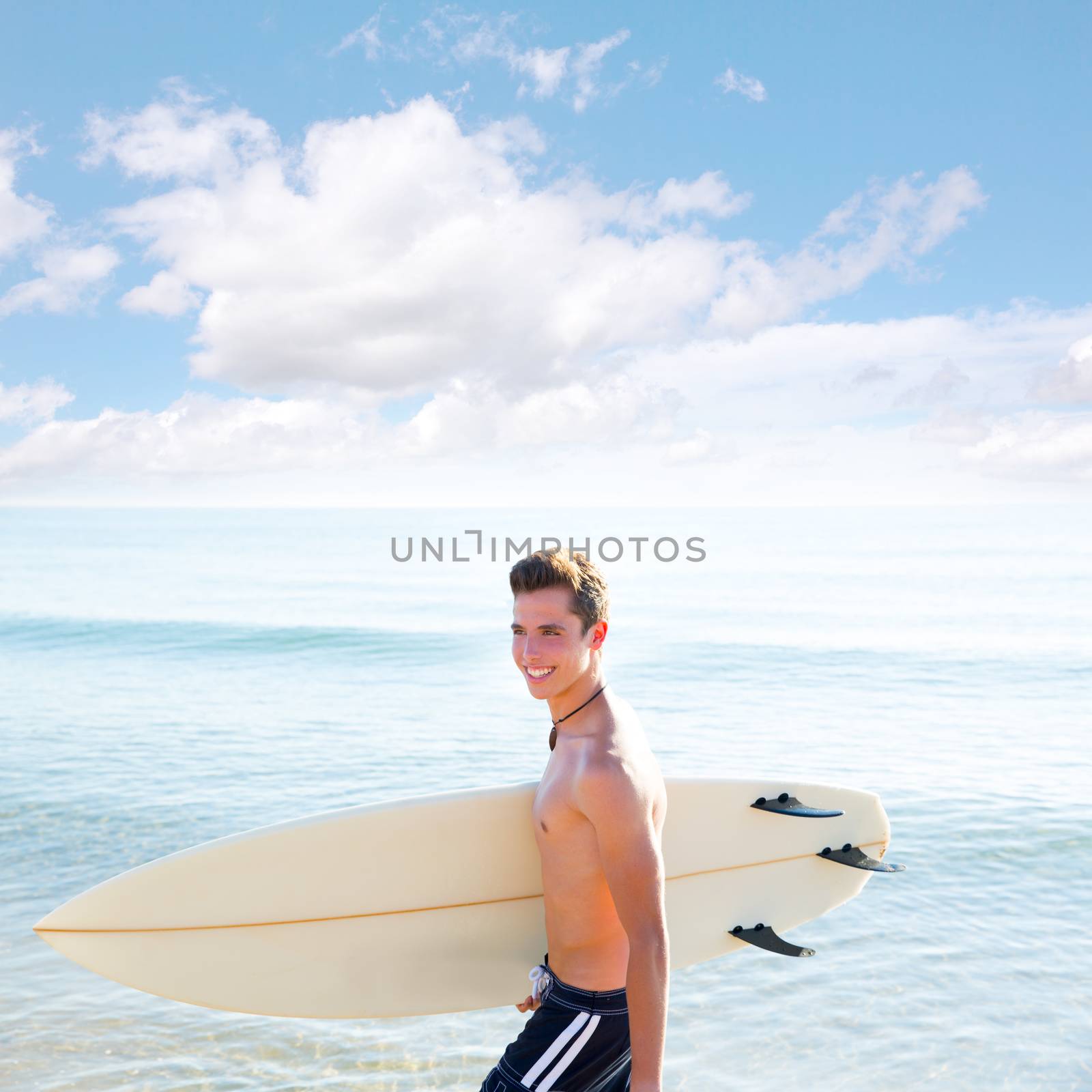 Surfer handsome boy teenager with surfboard in beach shore