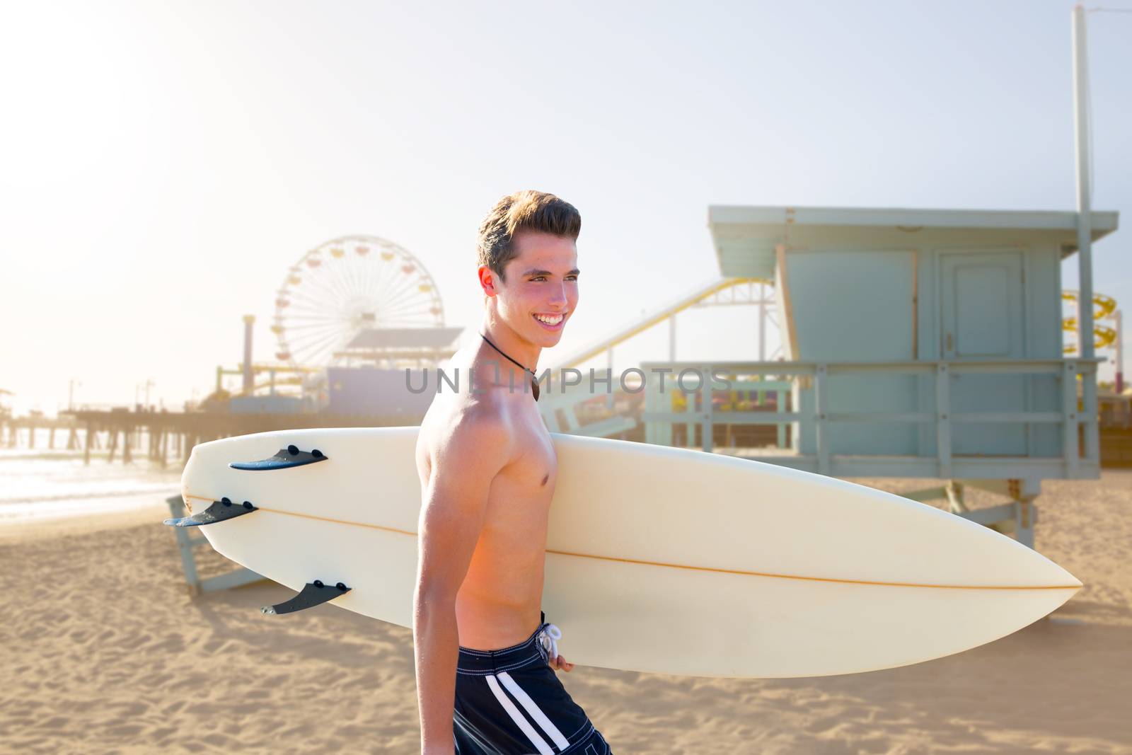 Surfer boy teenager with surfboard in Santa Monica Lifeguard house California