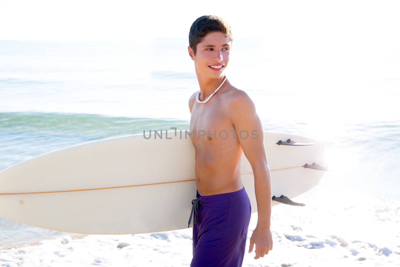 Surfer handsome boy teenager with surfboard in beach shore