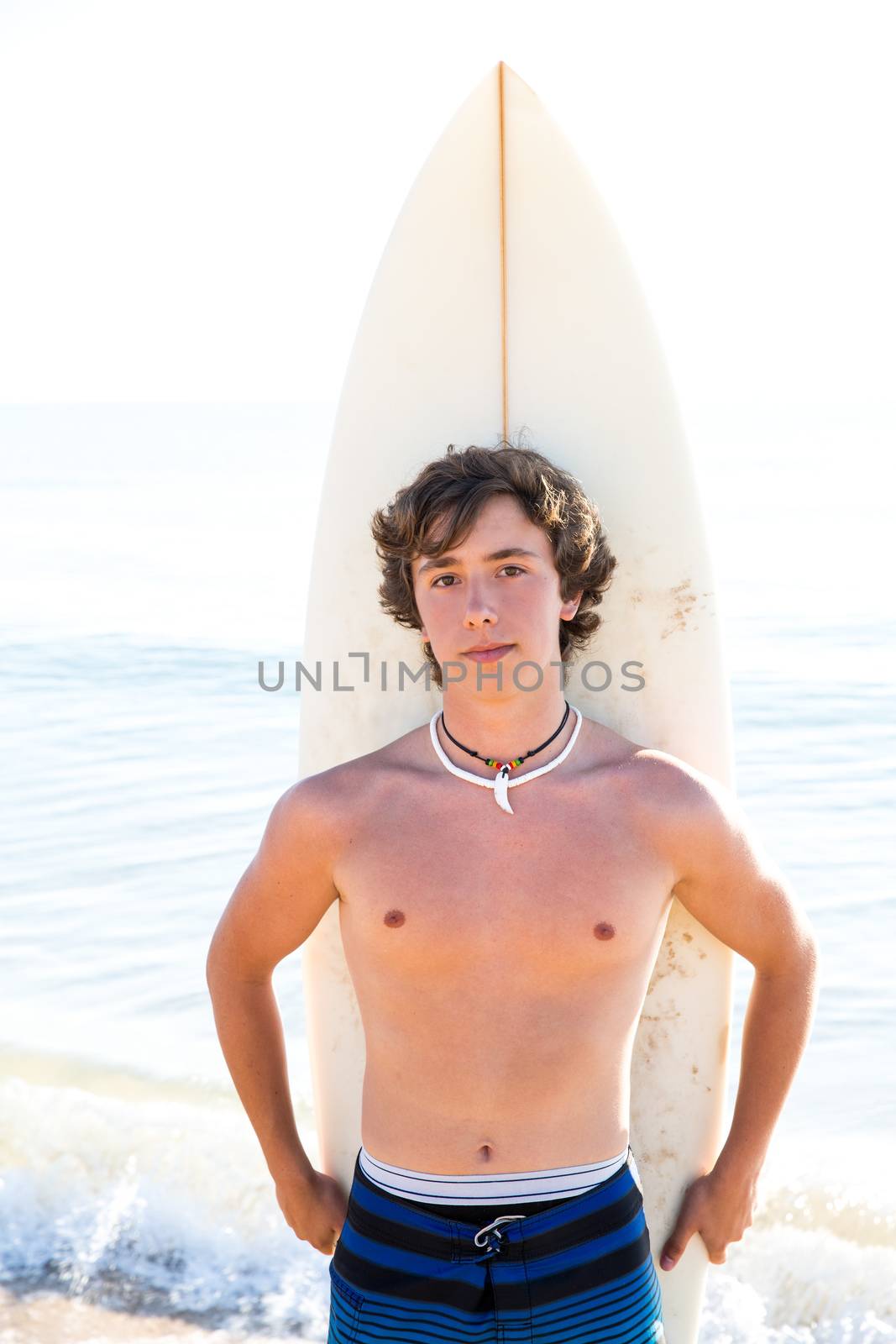 Surfer handsome boy teenager with surfboard in beach shore