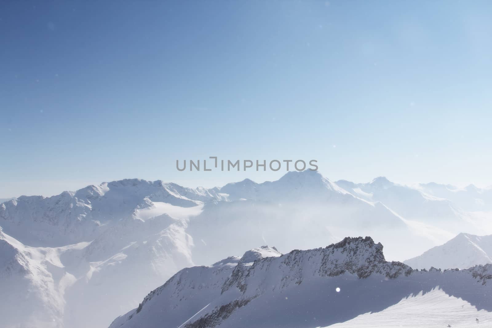 Mountain peaks of winter alps under blue sky