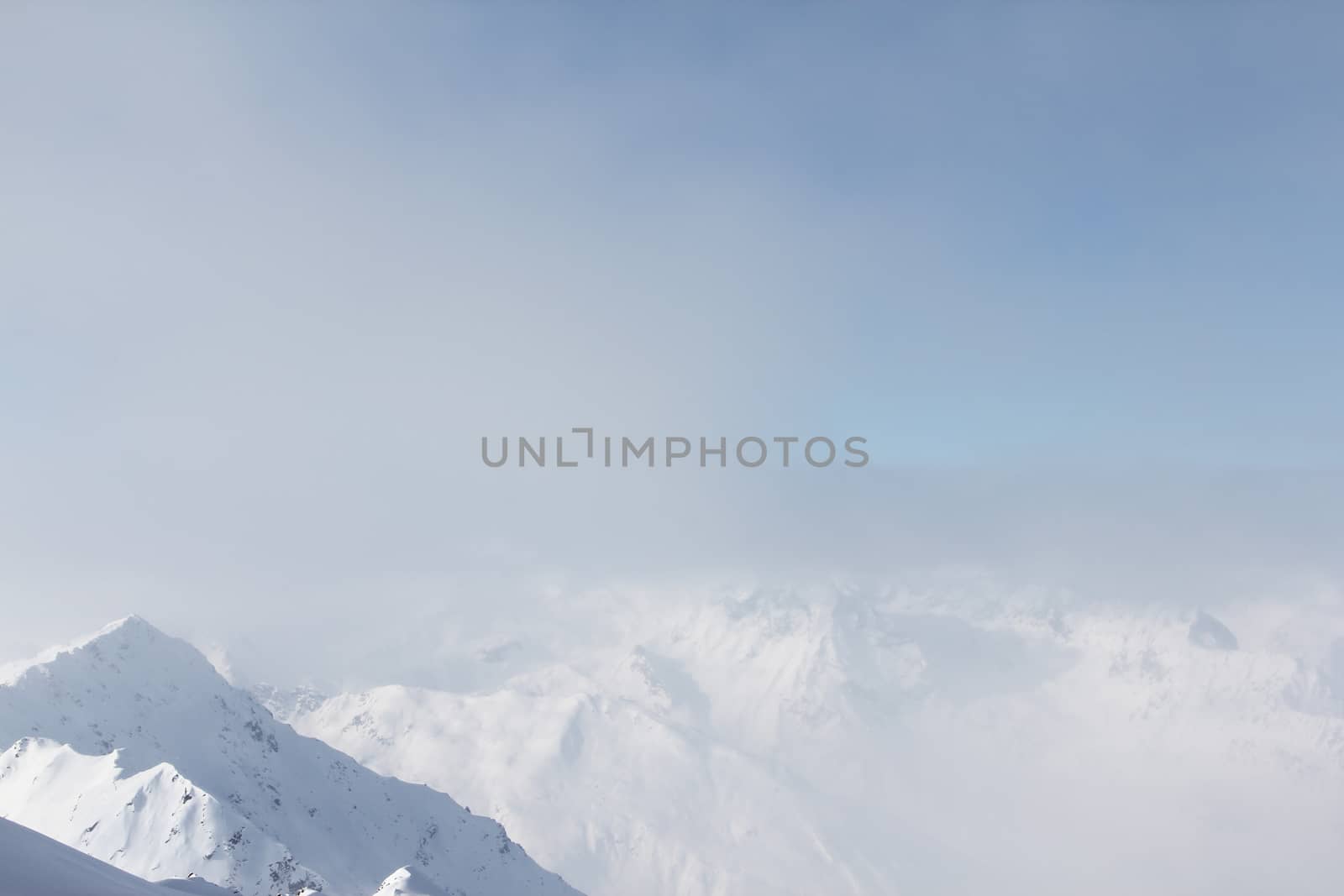 Mountain peaks of winter alps under blue sky