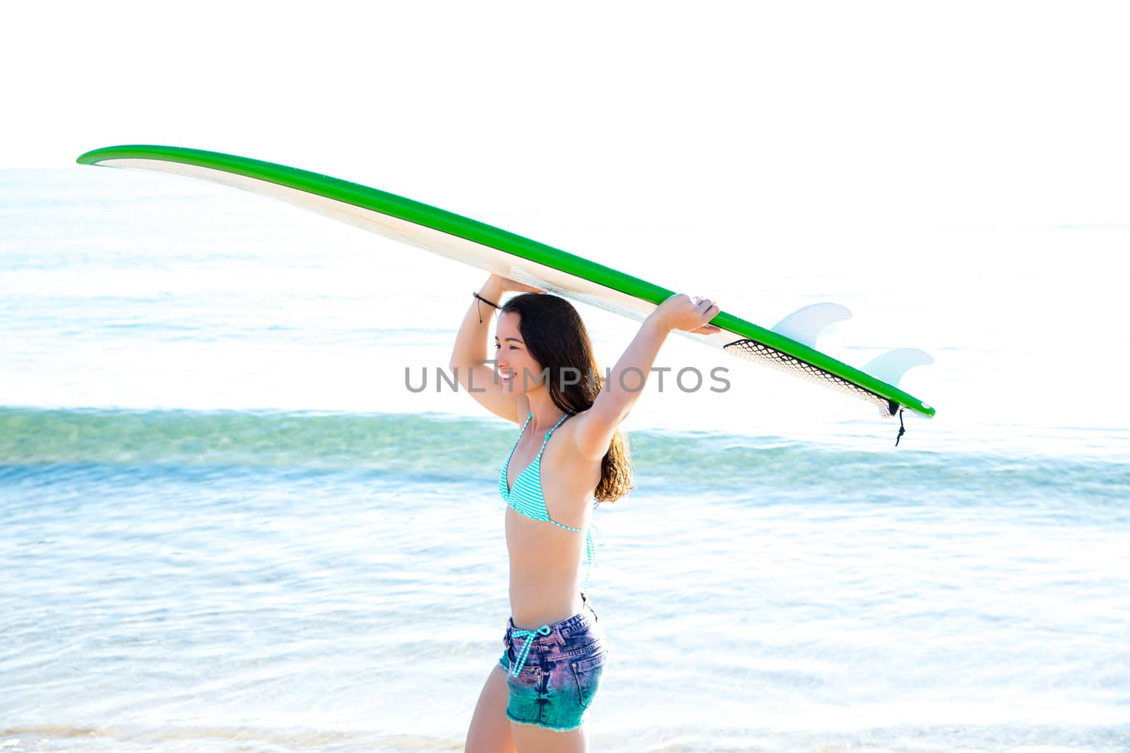 Surf girl with surfboard in beach shore by lunamarina