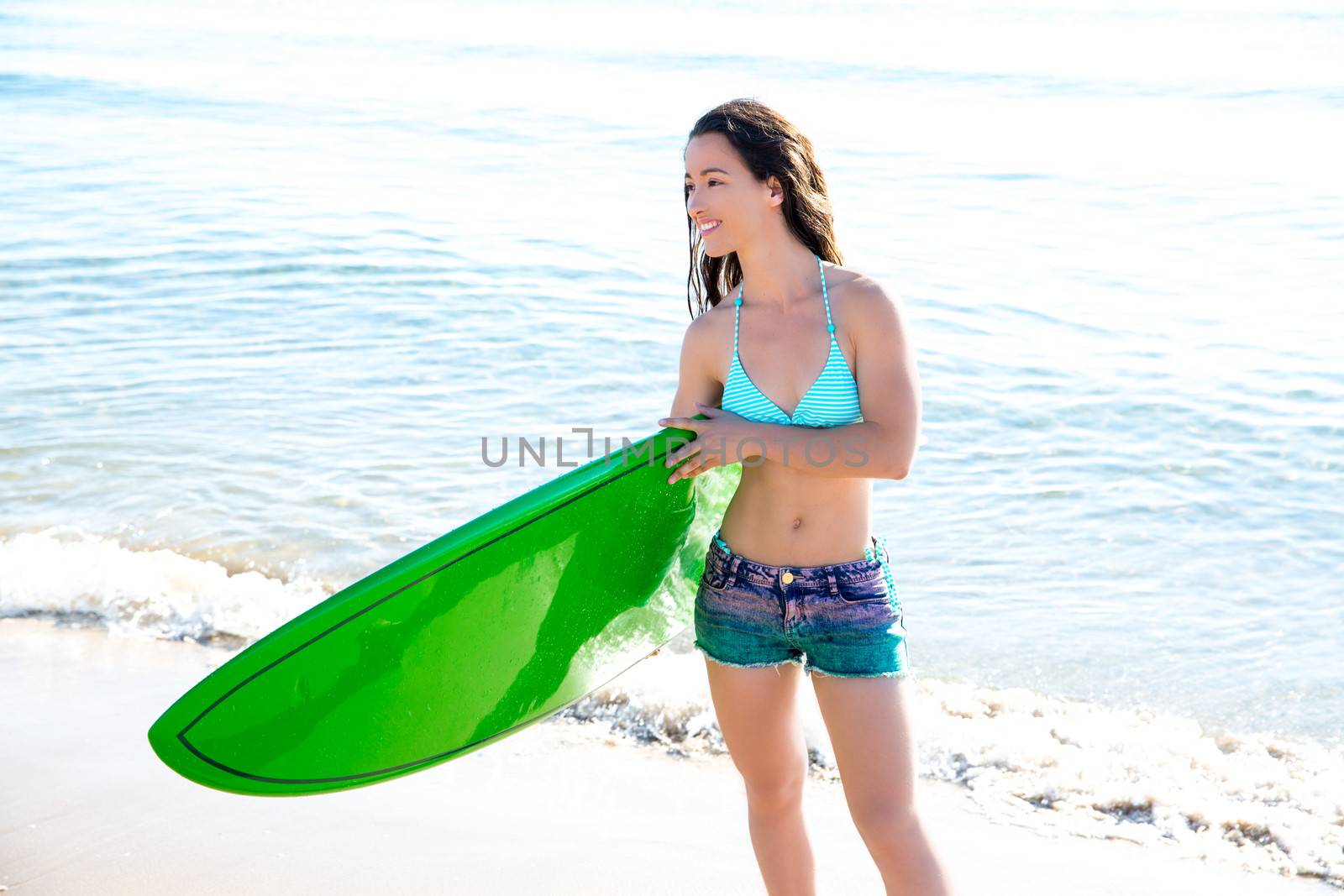 Surf girl with surfboard in beach shore by lunamarina