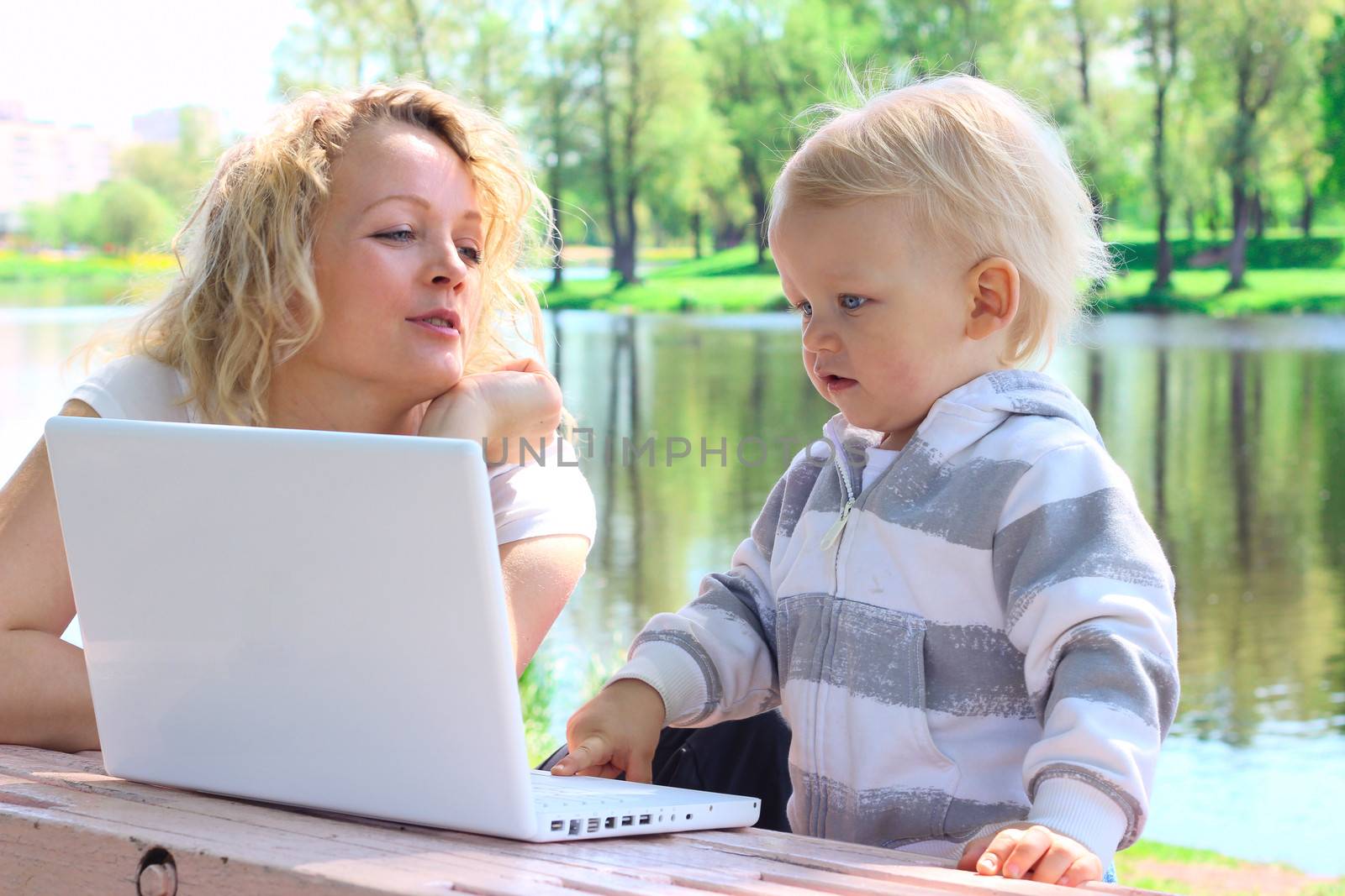 Mother and child with laptop by destillat