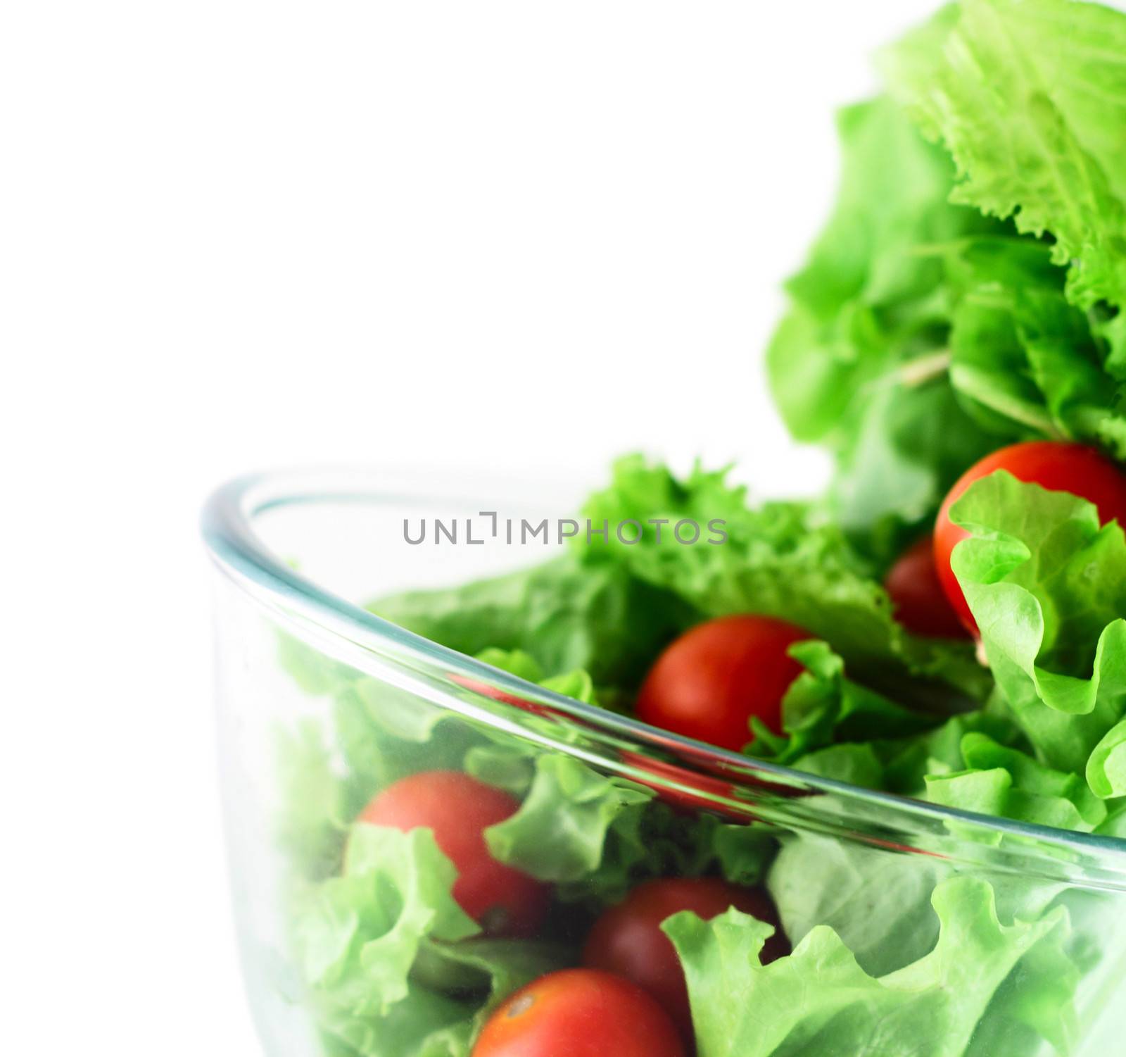  Light lettuce and cherry tomatoes salad close-up isolated on white lightness concept