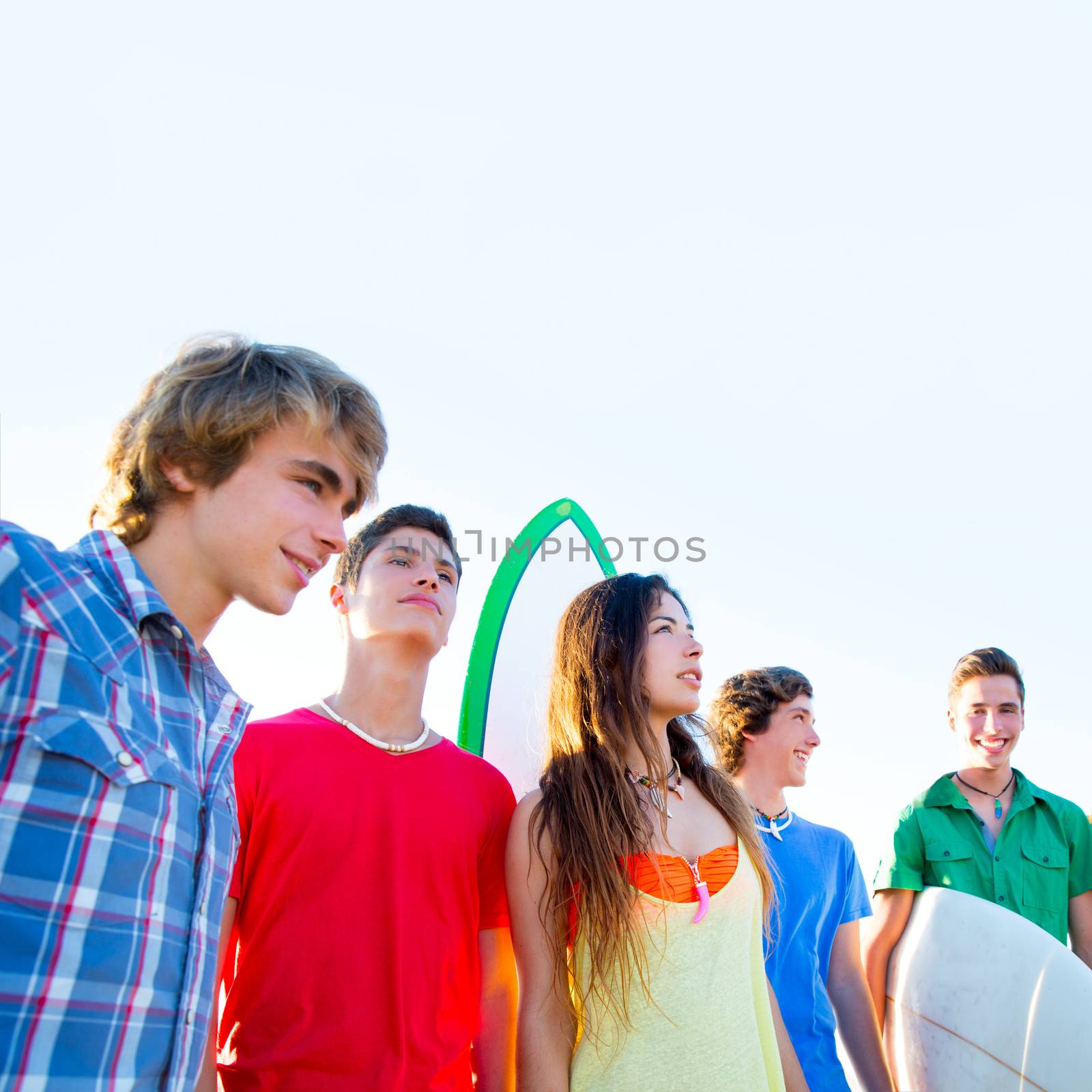 Teenager surfers boys and girls group happy in beach shore high key