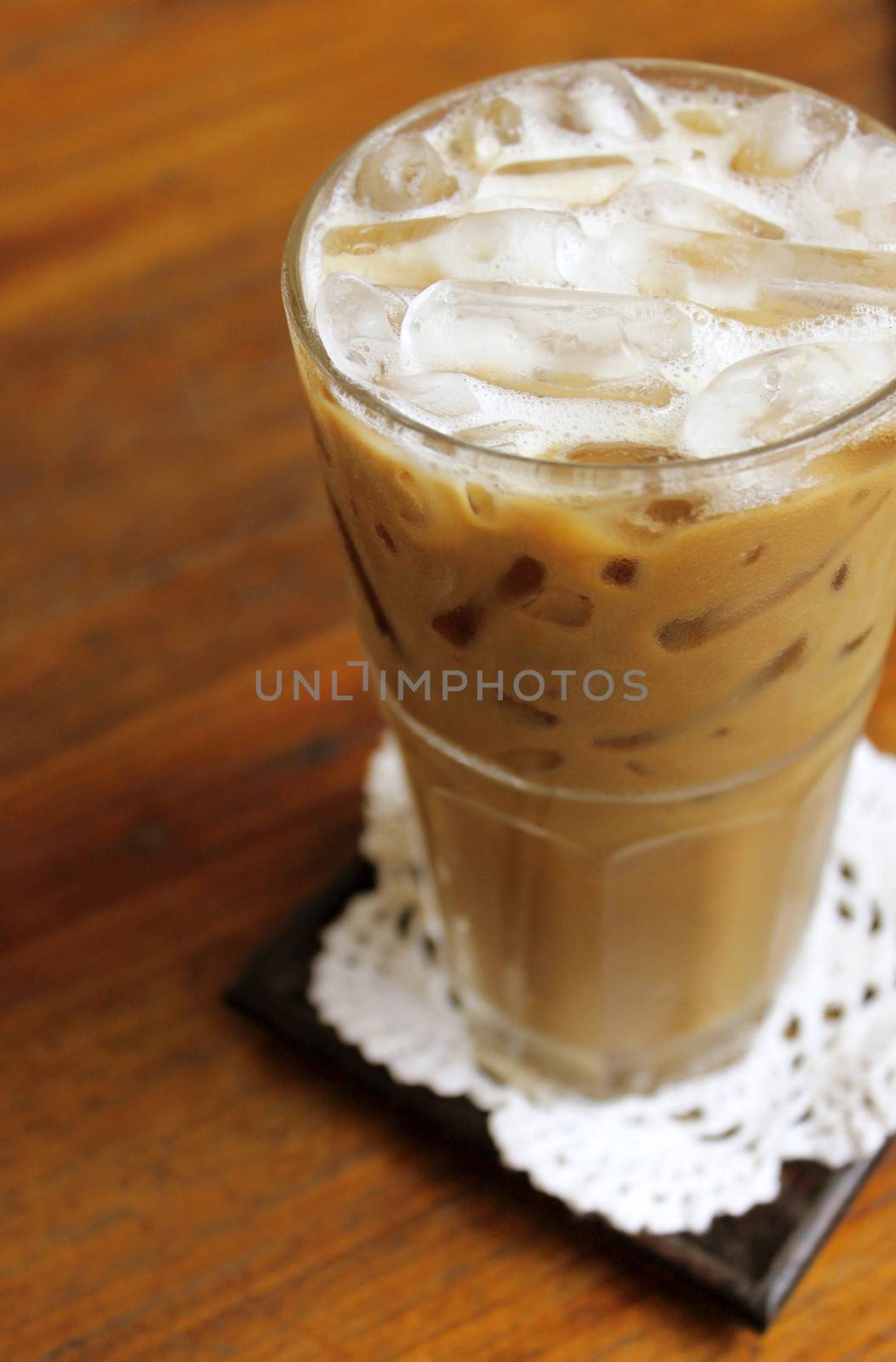 Iced coffee on wooden table by nuchylee