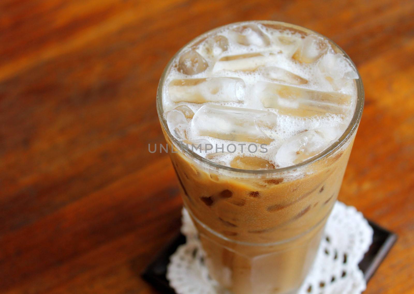 Iced coffee on wooden table by nuchylee