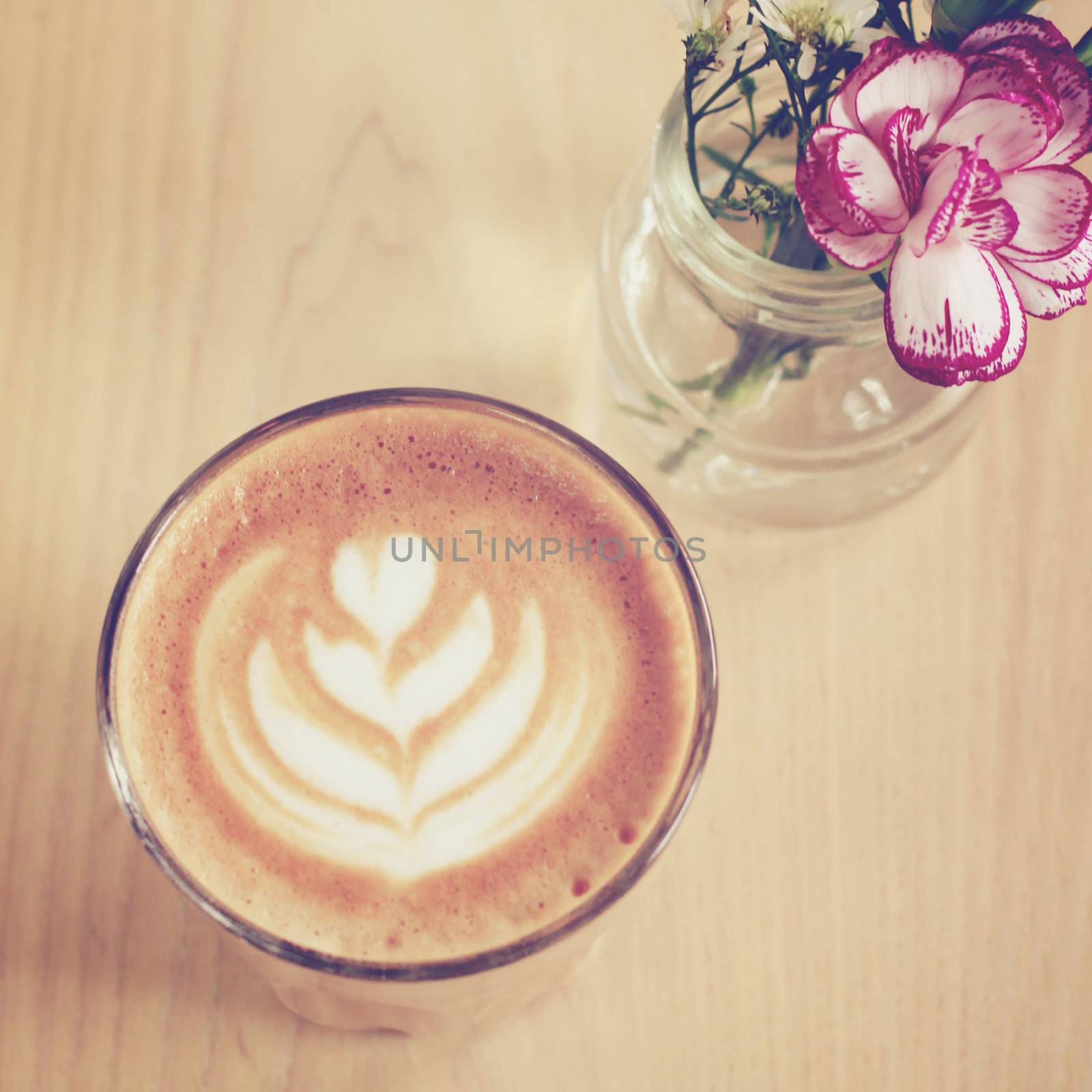 Cup of art latte or cappuccino coffee with flower, retro filter  by nuchylee