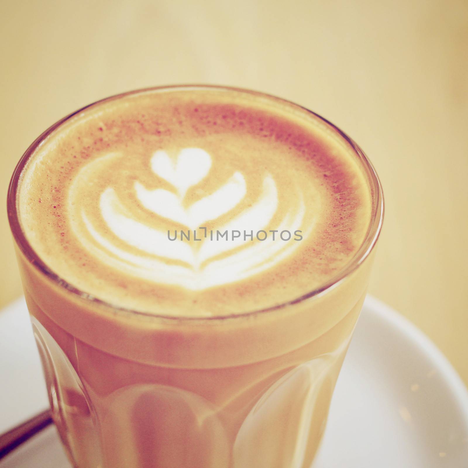 Cup of art latte or cappuccino coffee with retro filter effect by nuchylee