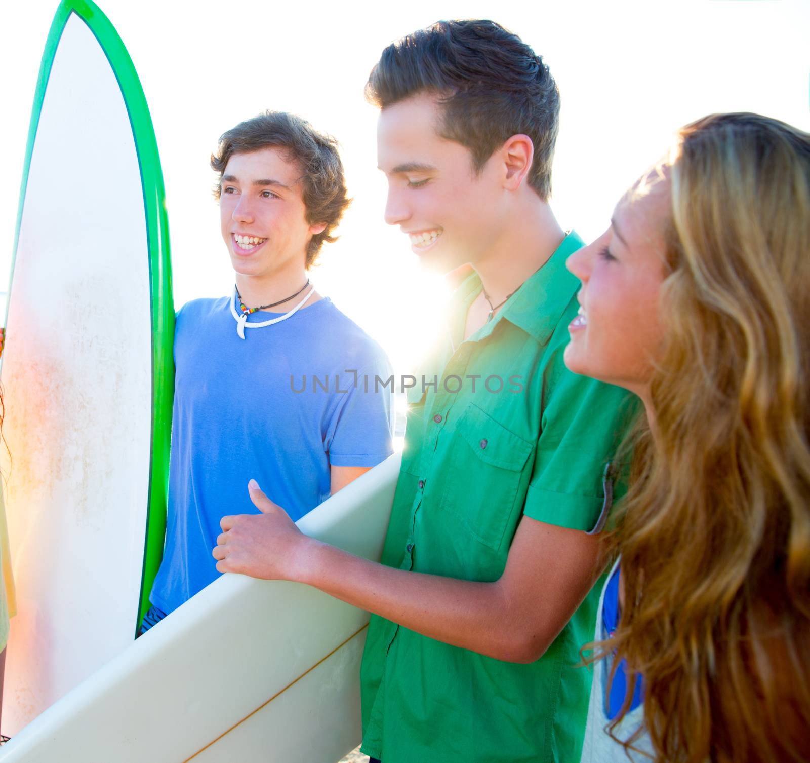 Teenager surfers group happy in beach shore high key