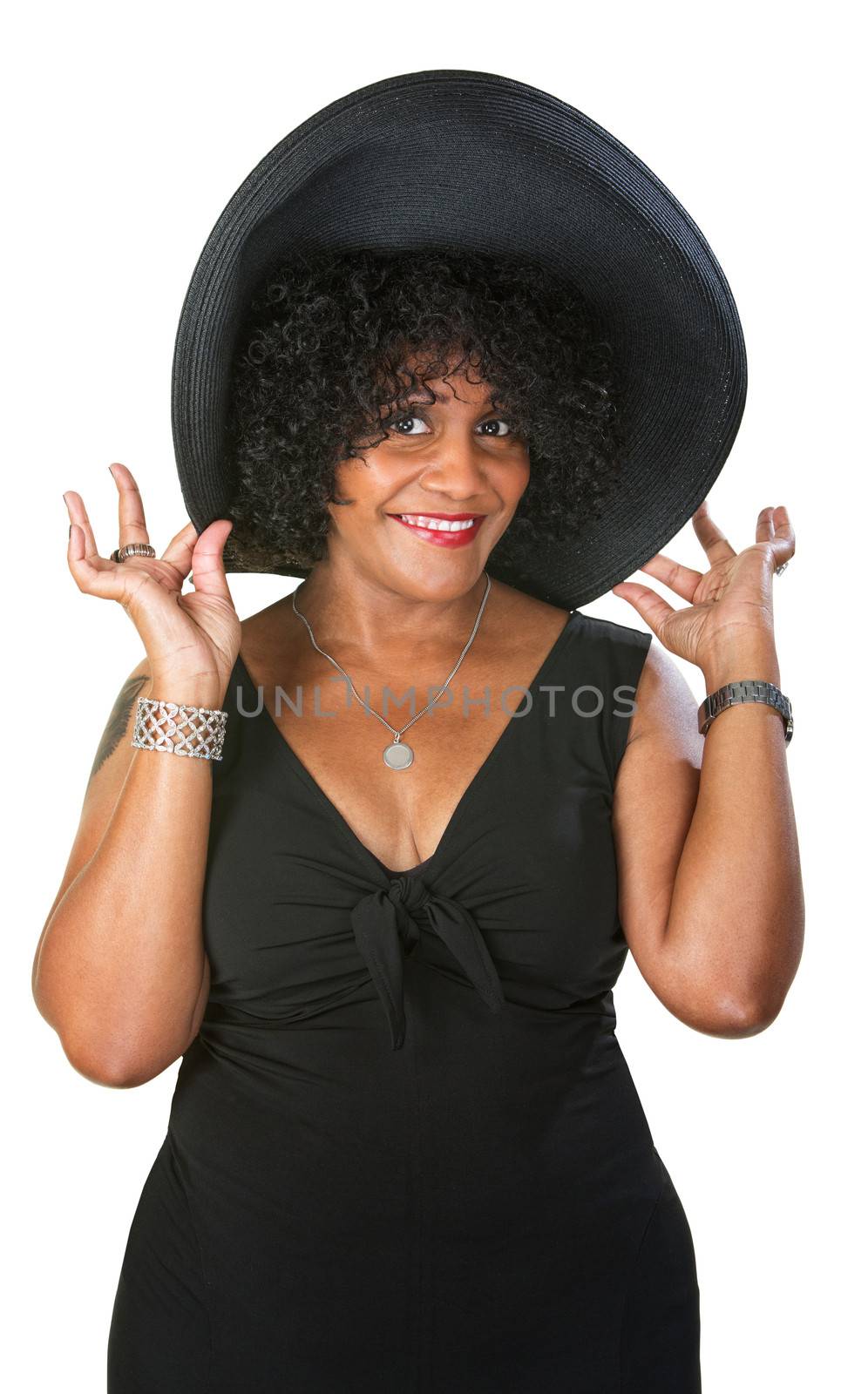 Cute flattered Hispanic woman holding oversized hat
