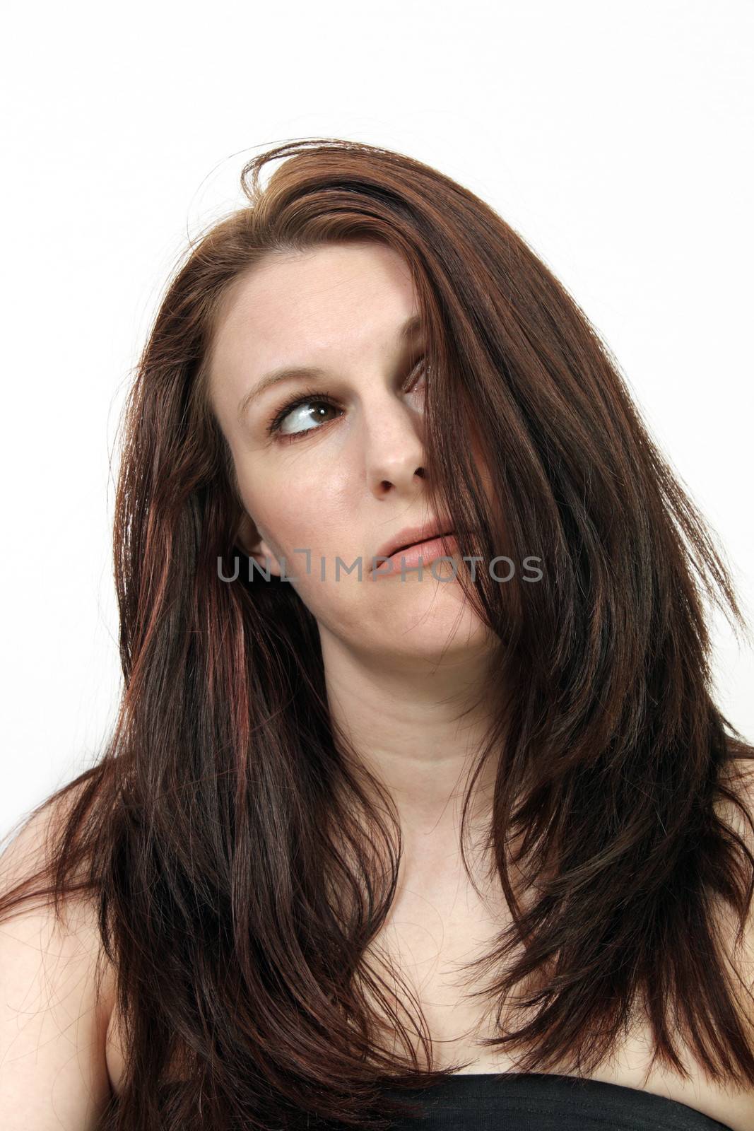 A close-up of a beautiful young brunette who appears to be tired, frustrated, or frazzled.
