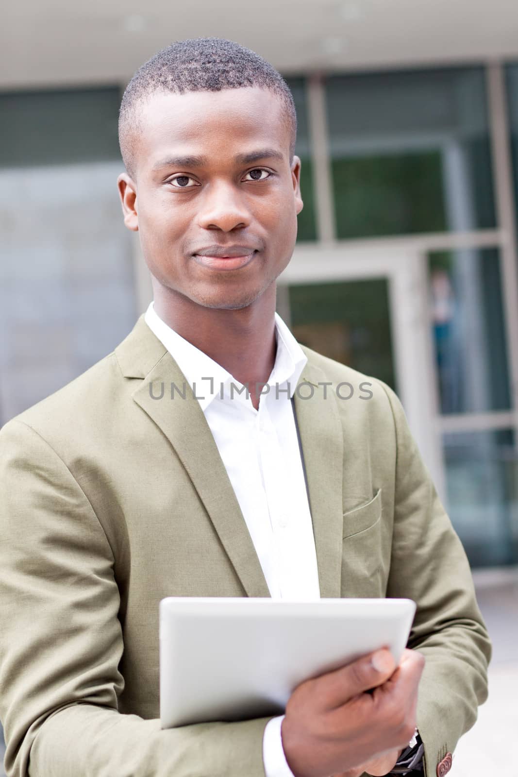 smiling successful businessman with tablet pc outdoor in summer 