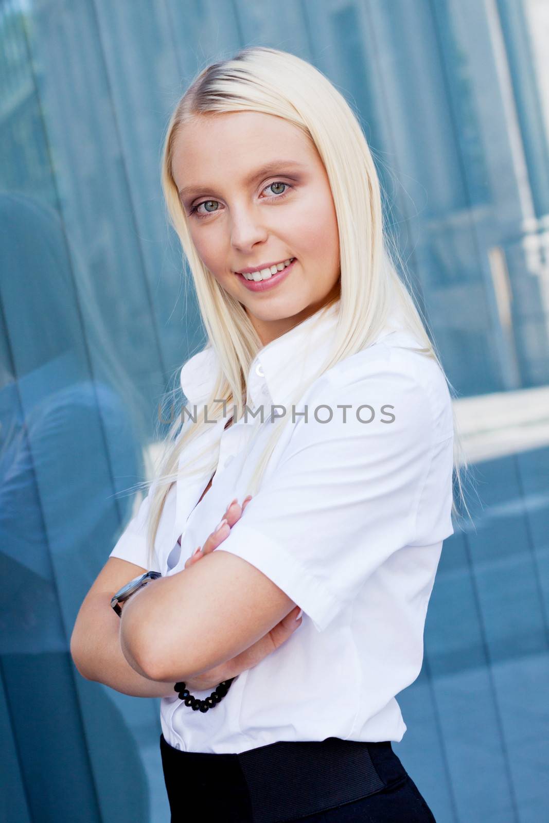 attractive young successful smiling business woman standing outdoor in summer 