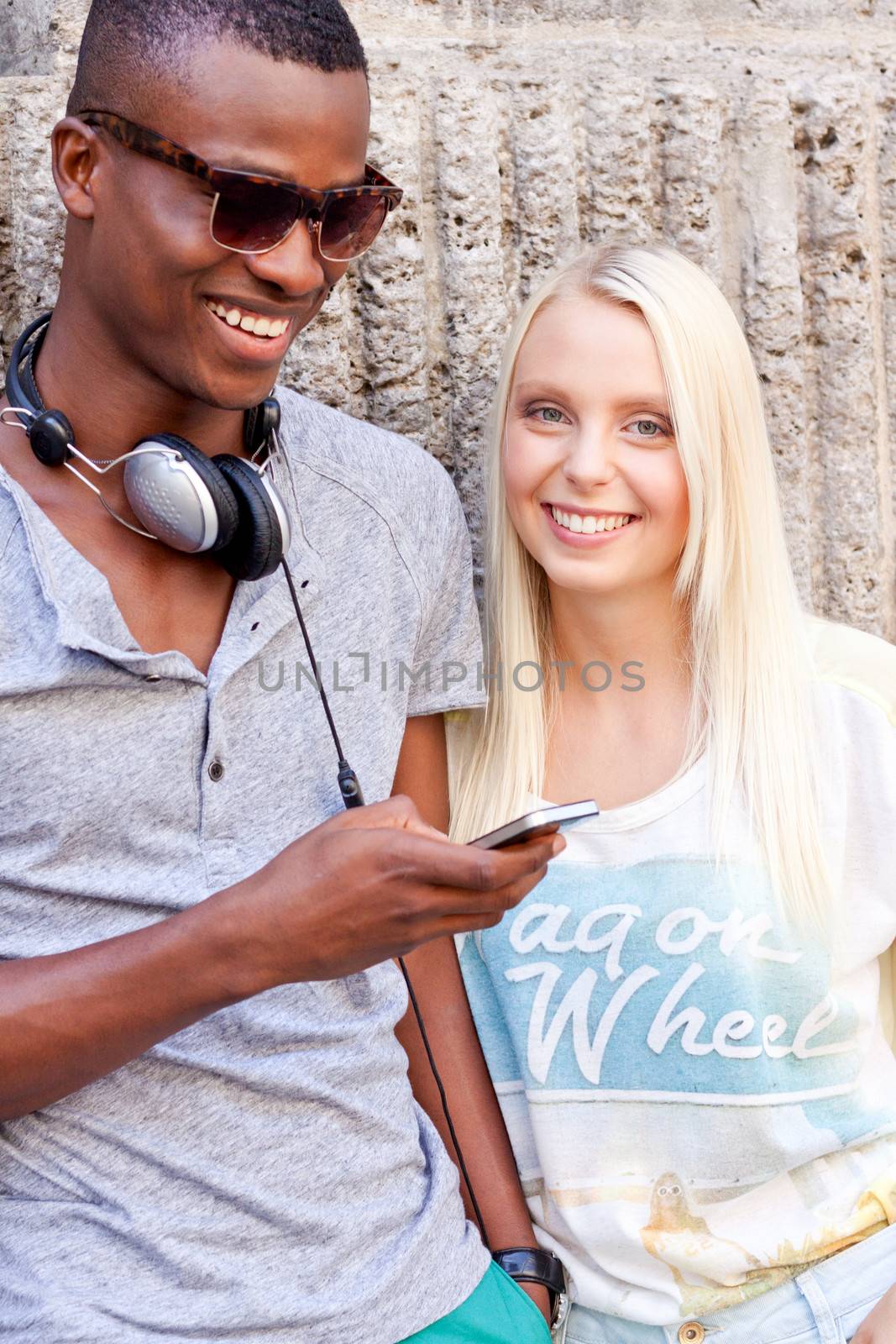 happy young couple have fun in the city summertime outdoor smiling lifestyle