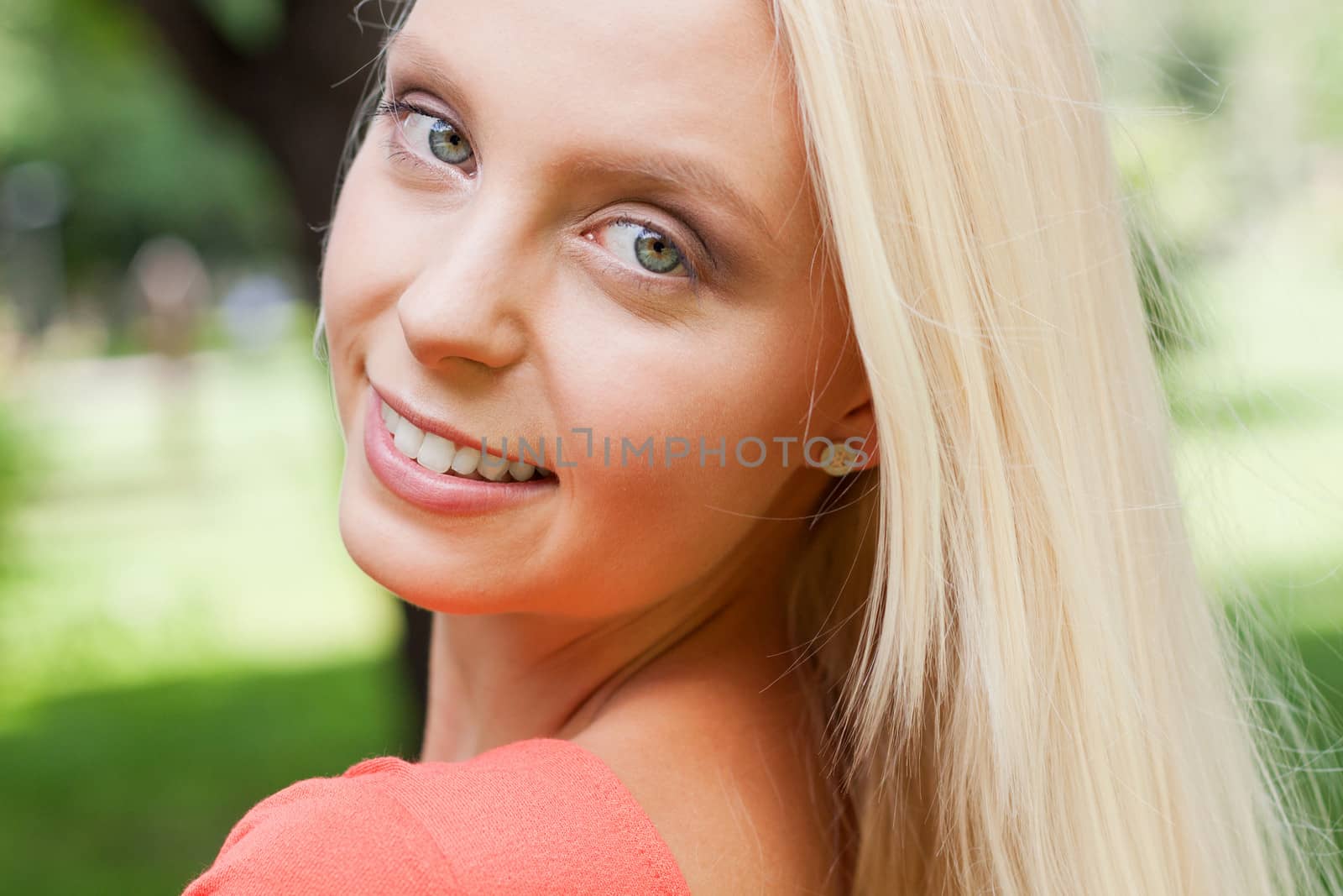 beautiful young blonde girl lying in grass summertime outdoor in park