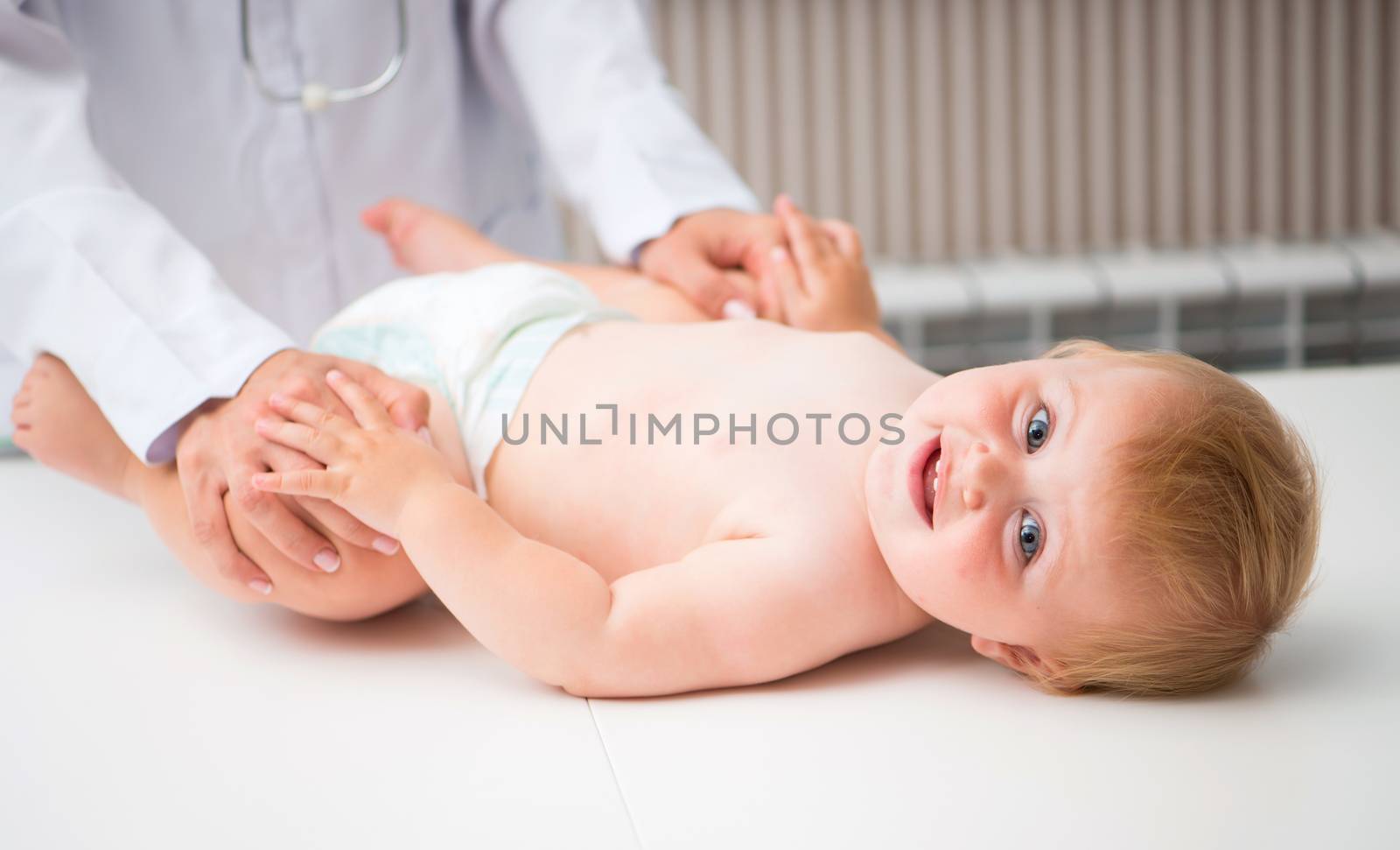 Masseuse massaging little cute baby