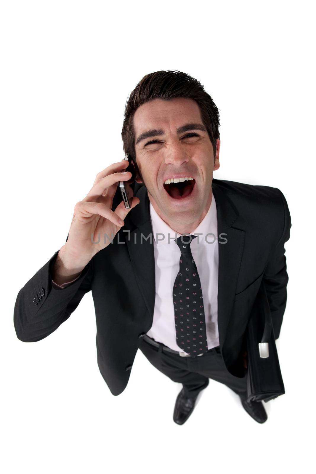 Businessman laughing out loud during call by phovoir