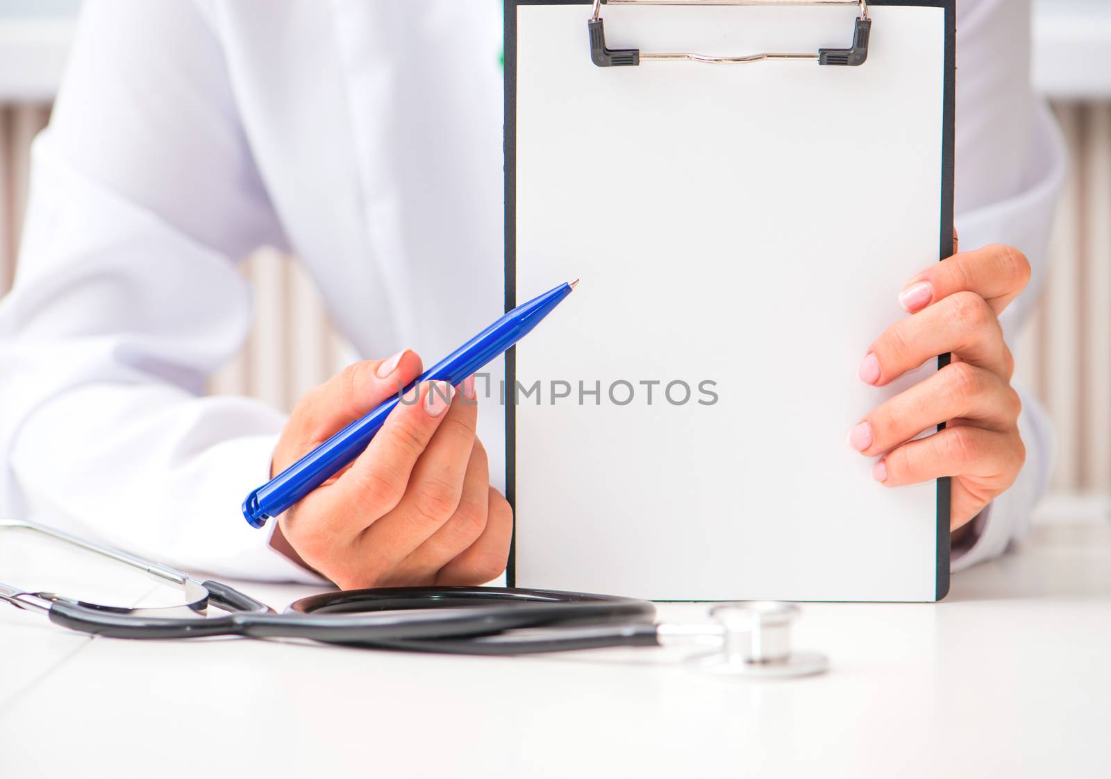 doctor's hands with a plane-table shows pen