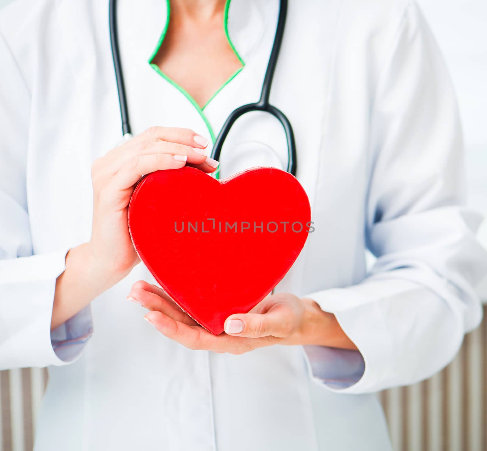 Doctor's hands with red heart close up