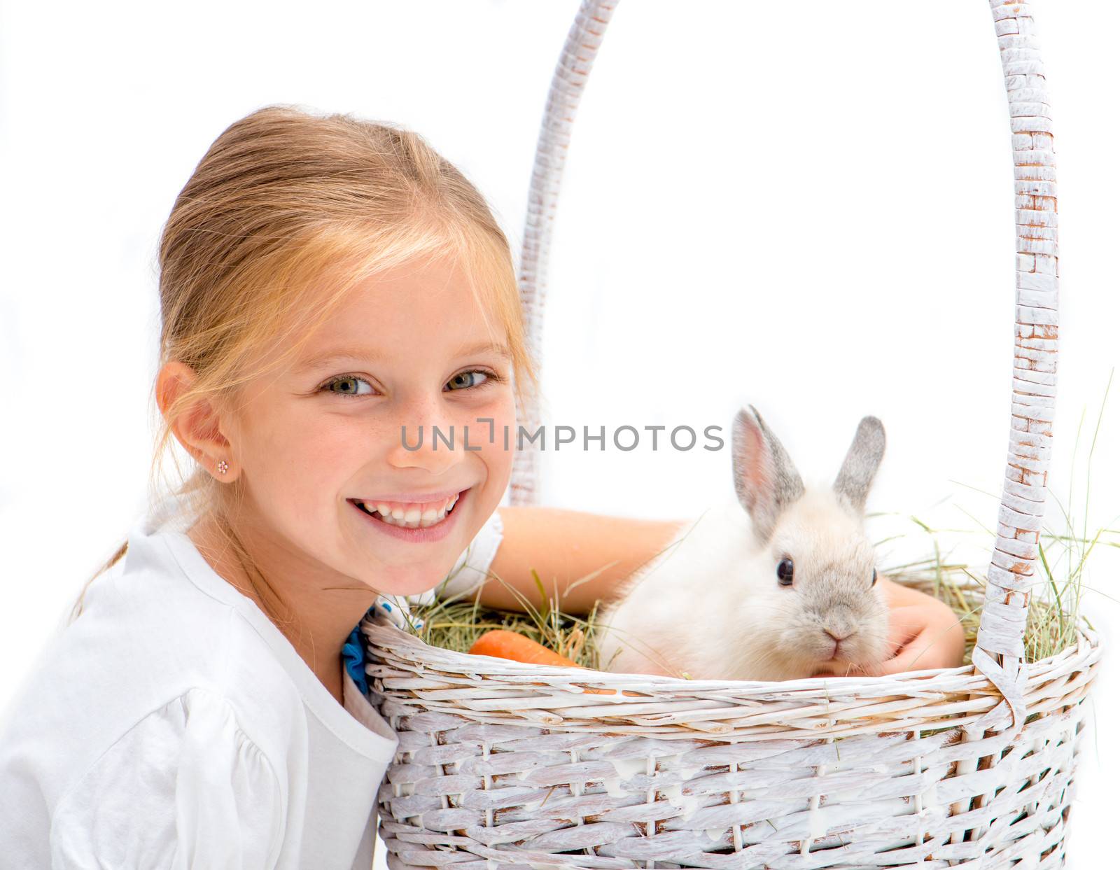 Smiling Little girl with a rabbit in basket